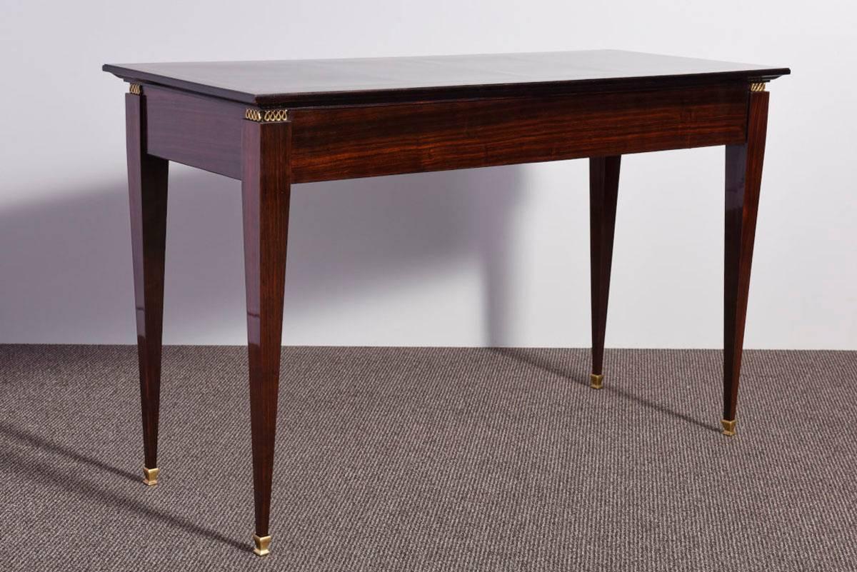 Very elegant, 1950s Mid-Century Modern designed, Italian origin dark rosewood veneered console table or desk with three drawers.
Sycamore inlay on the top as well as on the drawers. Brass sabots and handels and key. The desk was completely restored