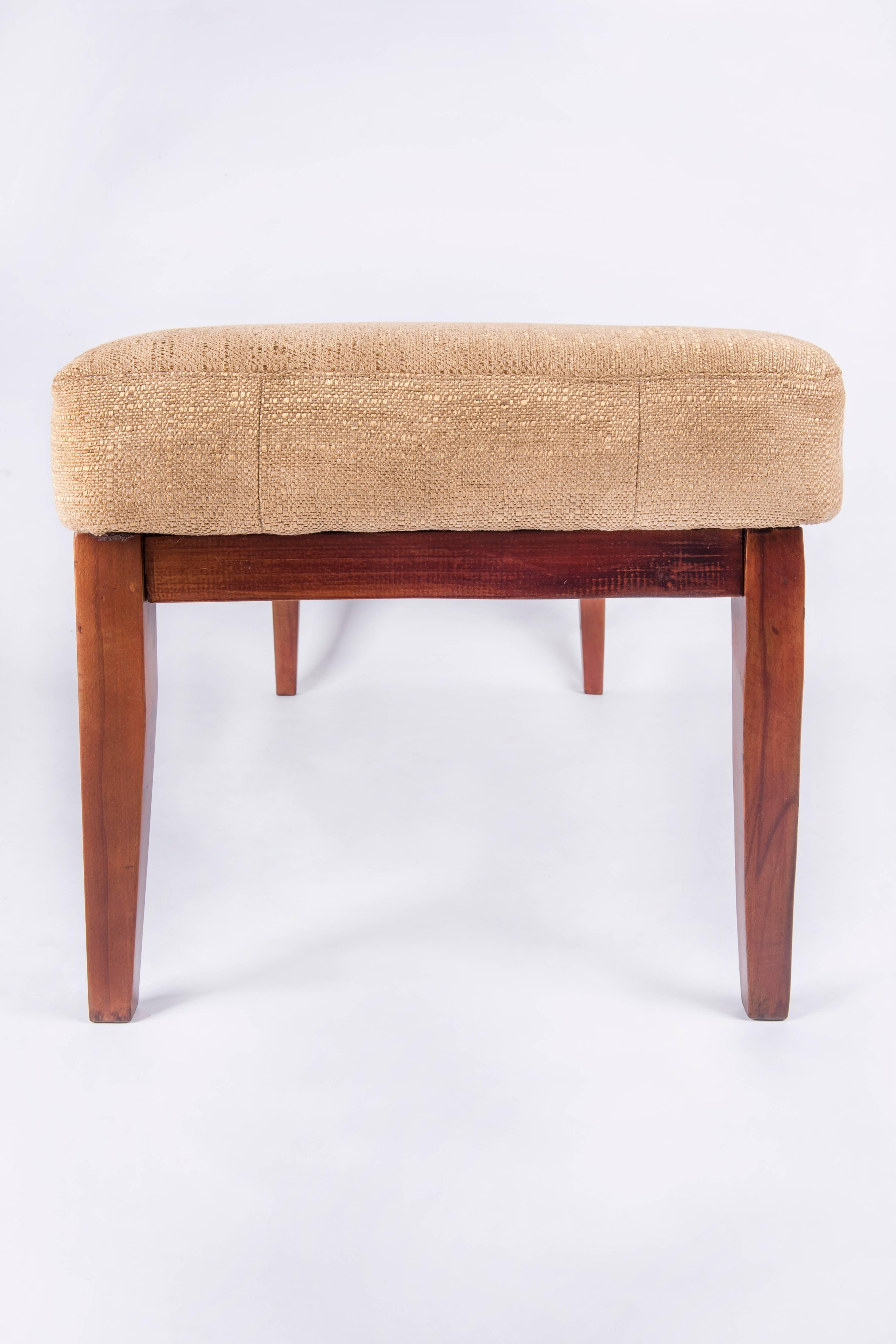 A very elegant 1960s solid beech wood bench. The piece was completely restored, refurbished .The wooden frame was repolished and it's reupholstered with a golden colored fabric (cotton and silk).