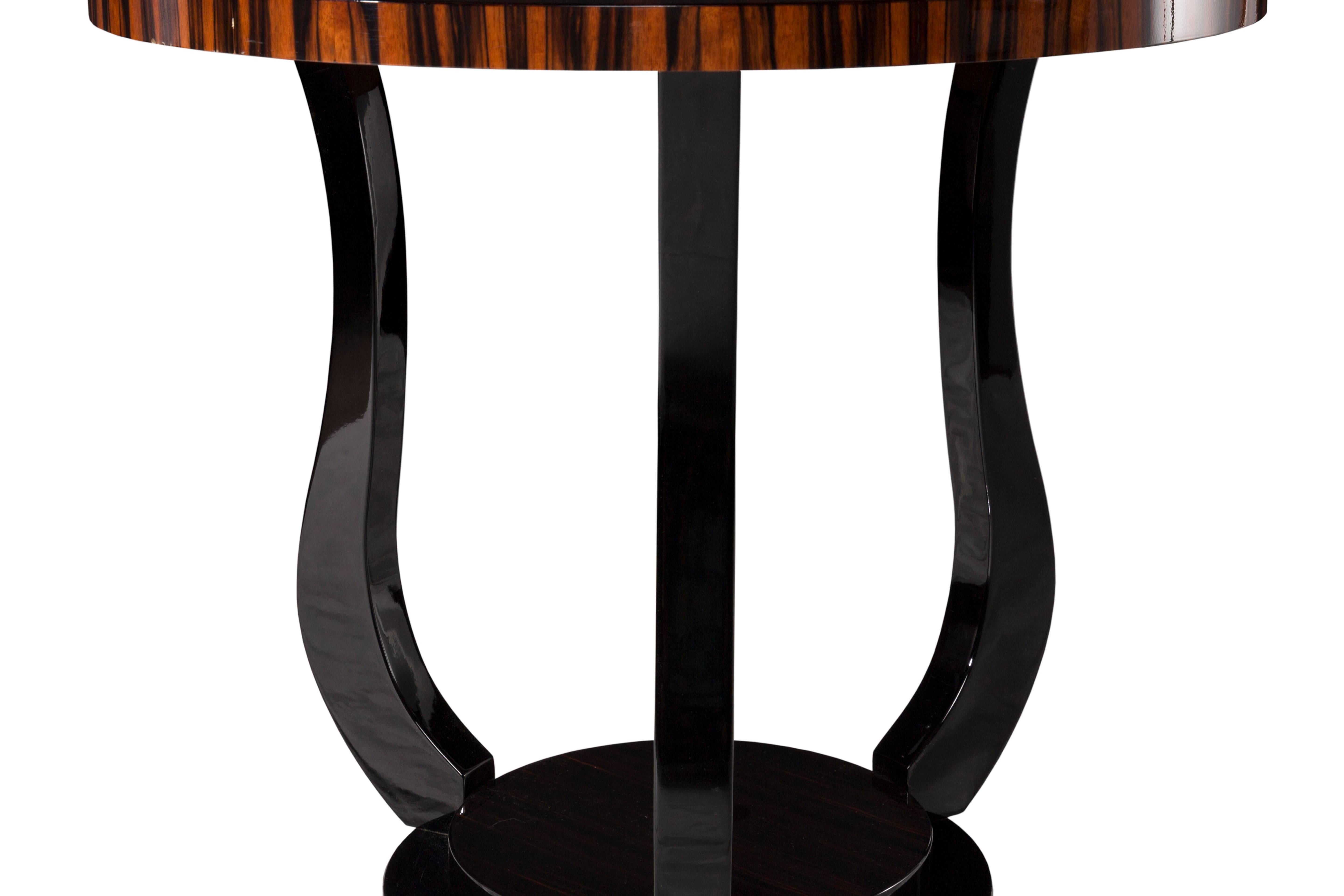 A pair of French origin ebony Macassar veneered art-deco tables. This very elegant model can be used as a side table or a coffee table as well as a centre table.
The base is black lacquered and the ebony Macassar tabletop is finished with a hard