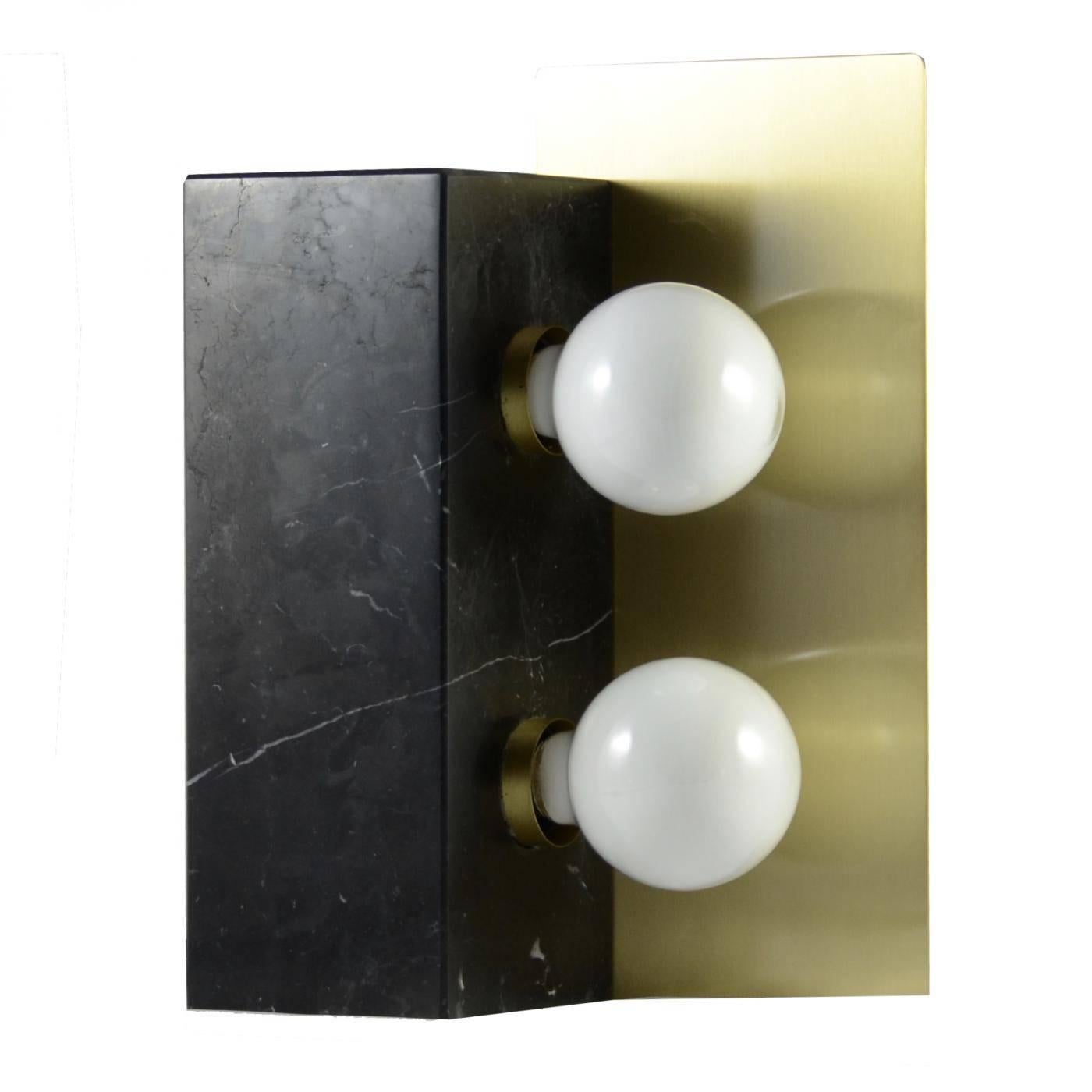 An extraordinary Italian design: the cubus table lamp. This model was designed for people loving the combinasion of modernism and precious materials.

The black Marquinia marble is holding two incandescence lightbulbs. The light is reflected by