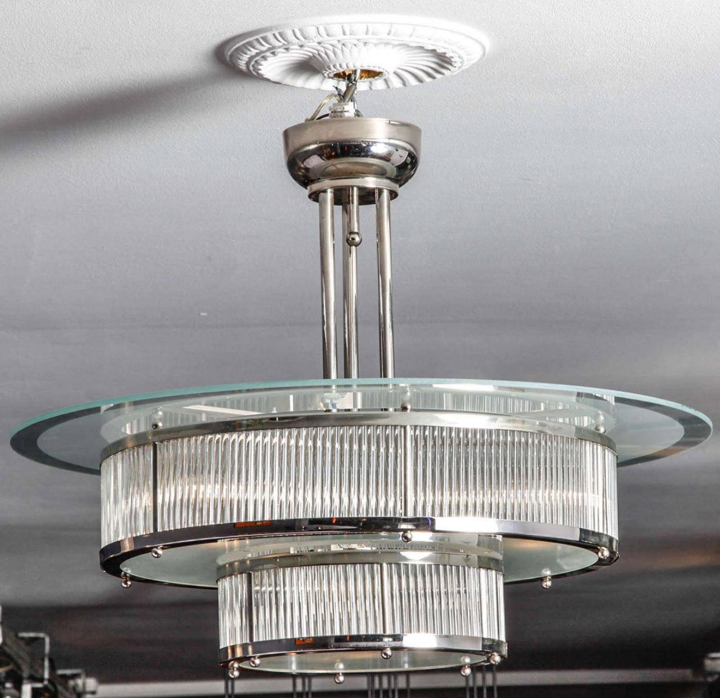 Art Deco chandelier designed by Atelier Petitot. Nickel-plated metal and glass.This model was designed in 1930 in France and was re edited in 2000. A beautiful modernist piece. Four electric bulbs in the bigger part and one in the middel underneath.