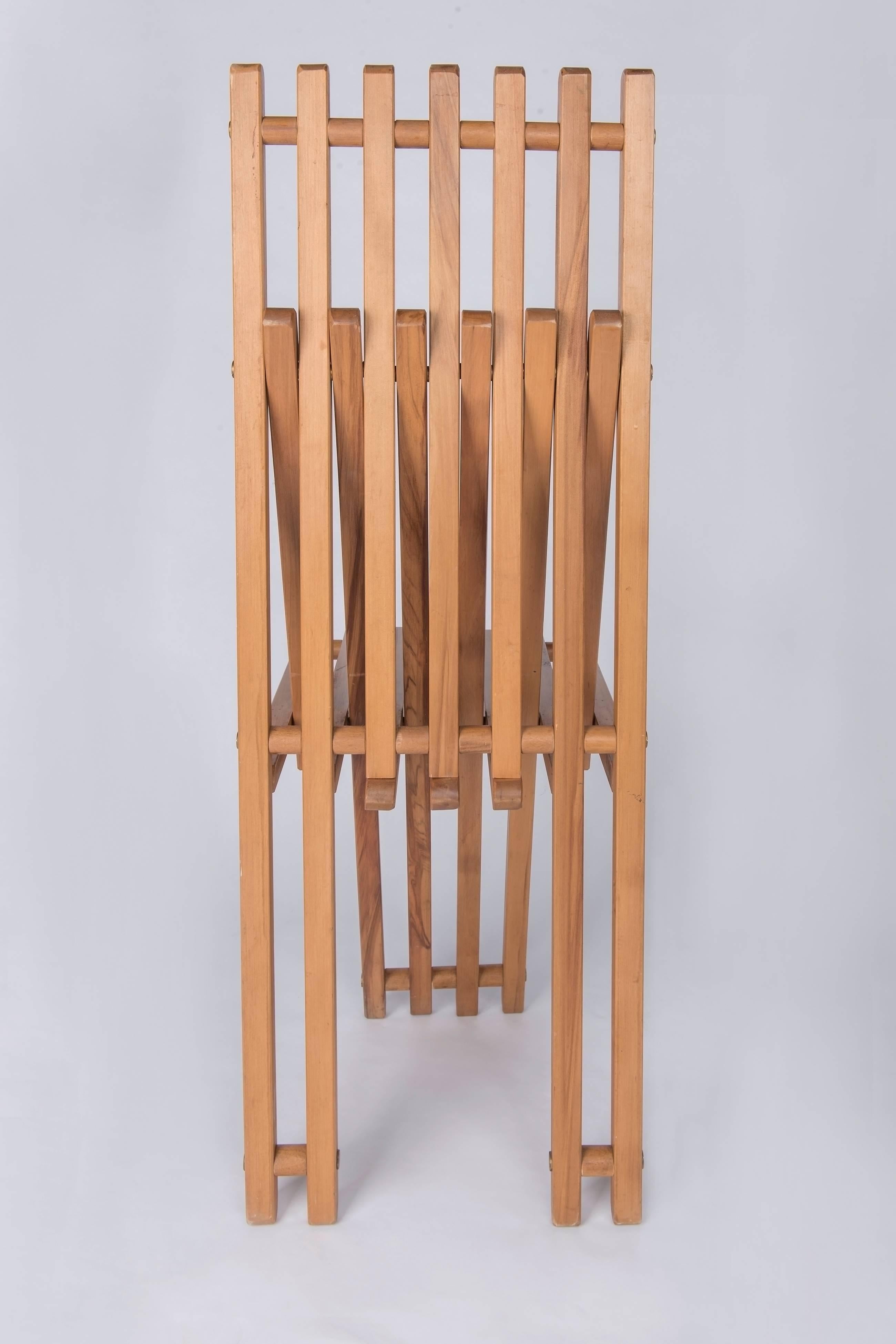 A pair of teak wood folding chairs edited by Capitini & Palmoni, stamped underneath. These chairs are the perfect examples how to combine comfort and design. They can be used as dining chairs as well as side chairs. They are in perfect authentic