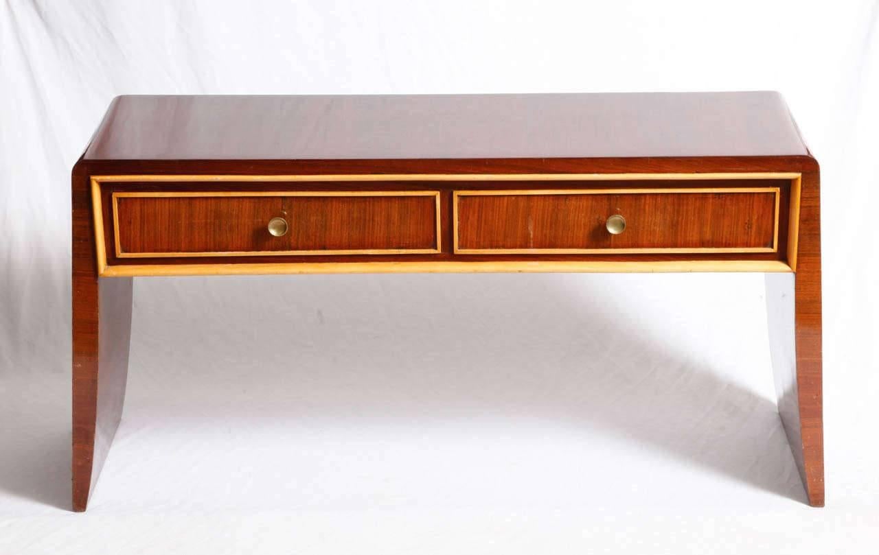 A very elegant Italian origin dark rosewood veneered art deco console. The two drawers are circled with sycamore wood. The back of the console is veneered as well, so it doesn't need to be placed against the wall. A very pretty piece.
Lustrous