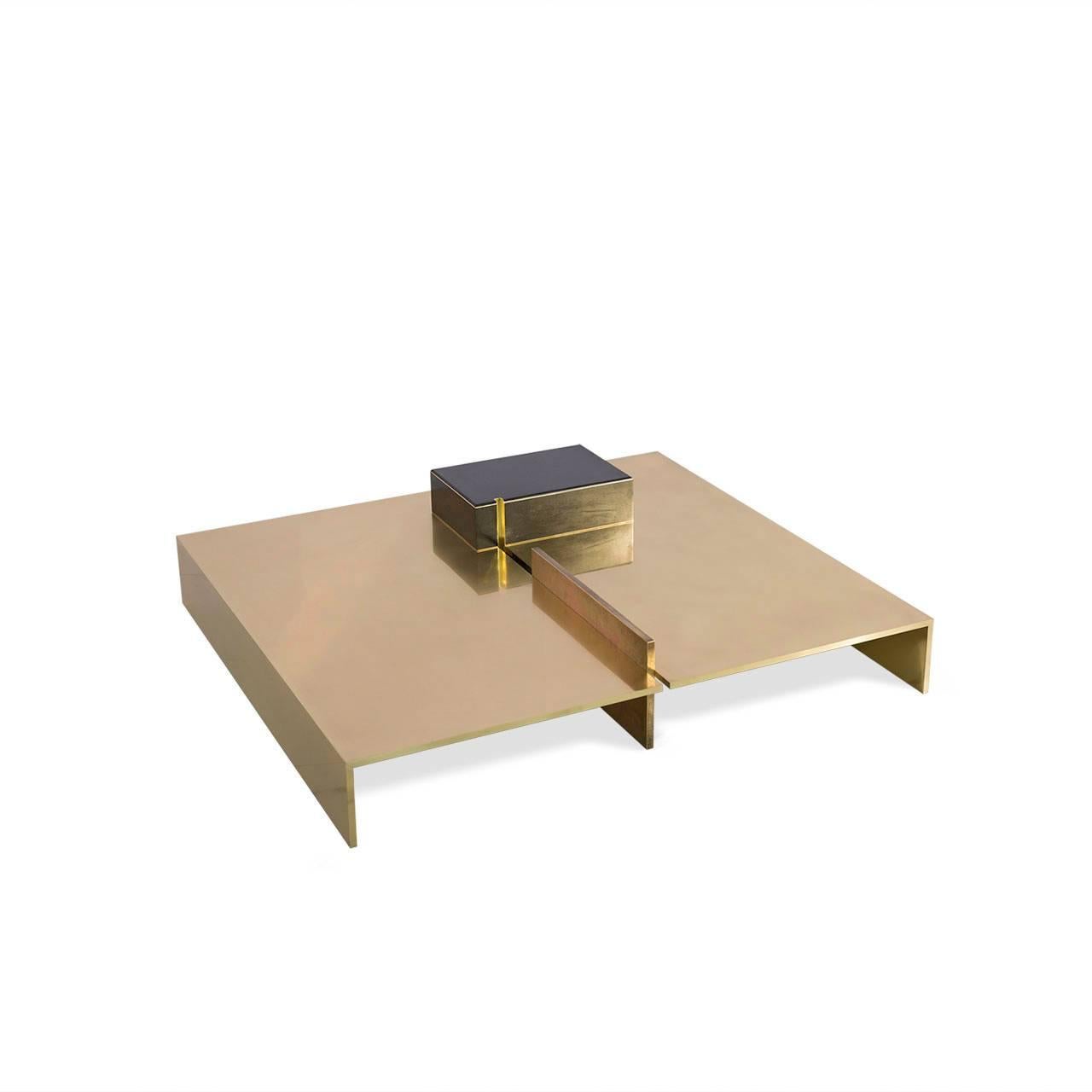 MMXVI series low sitting patinated brass center table. A slight Japanese aesthetic influence is present. The square design motif that rises above the base line of the piece has a resin coated wood inlay with embedded brass trim. Hand finished.