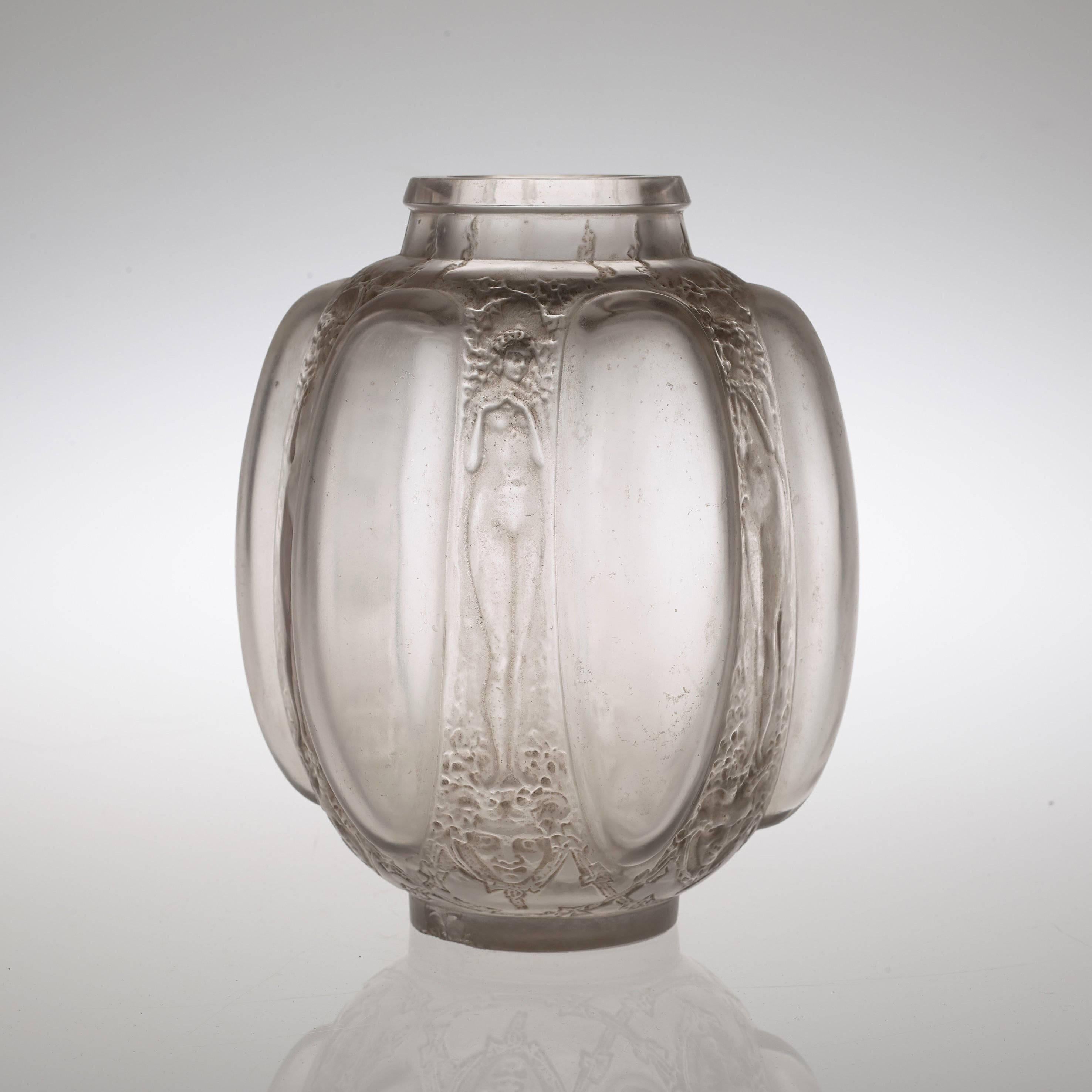 This vase was known to be designed in 1912. Related literature - Félix Marcilhac, 'René Lalique Catalogue Raisonné de l'oeuvre de Verre', catalogue no 886, p 414.

Genuine article. Base engraved 