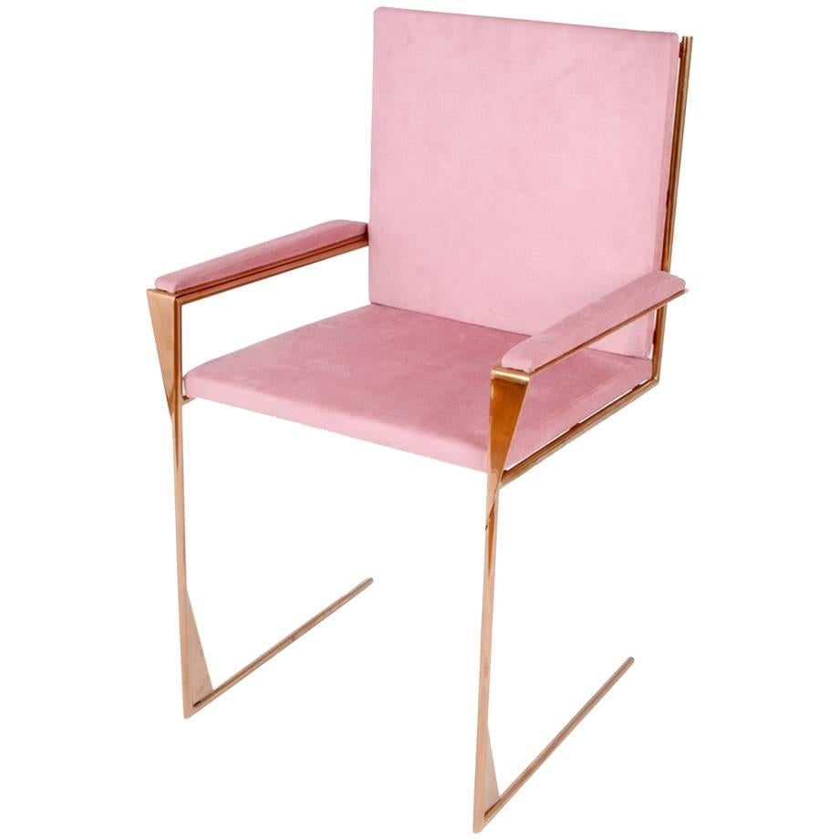 The frame chair resembles a fine piece of jewelry. A simple and delicate object, both beautiful to look at and comfortable to enjoy. The linear frame integrates a sleek rose-toned copper into the comforting texture of cotton velvet, creating a