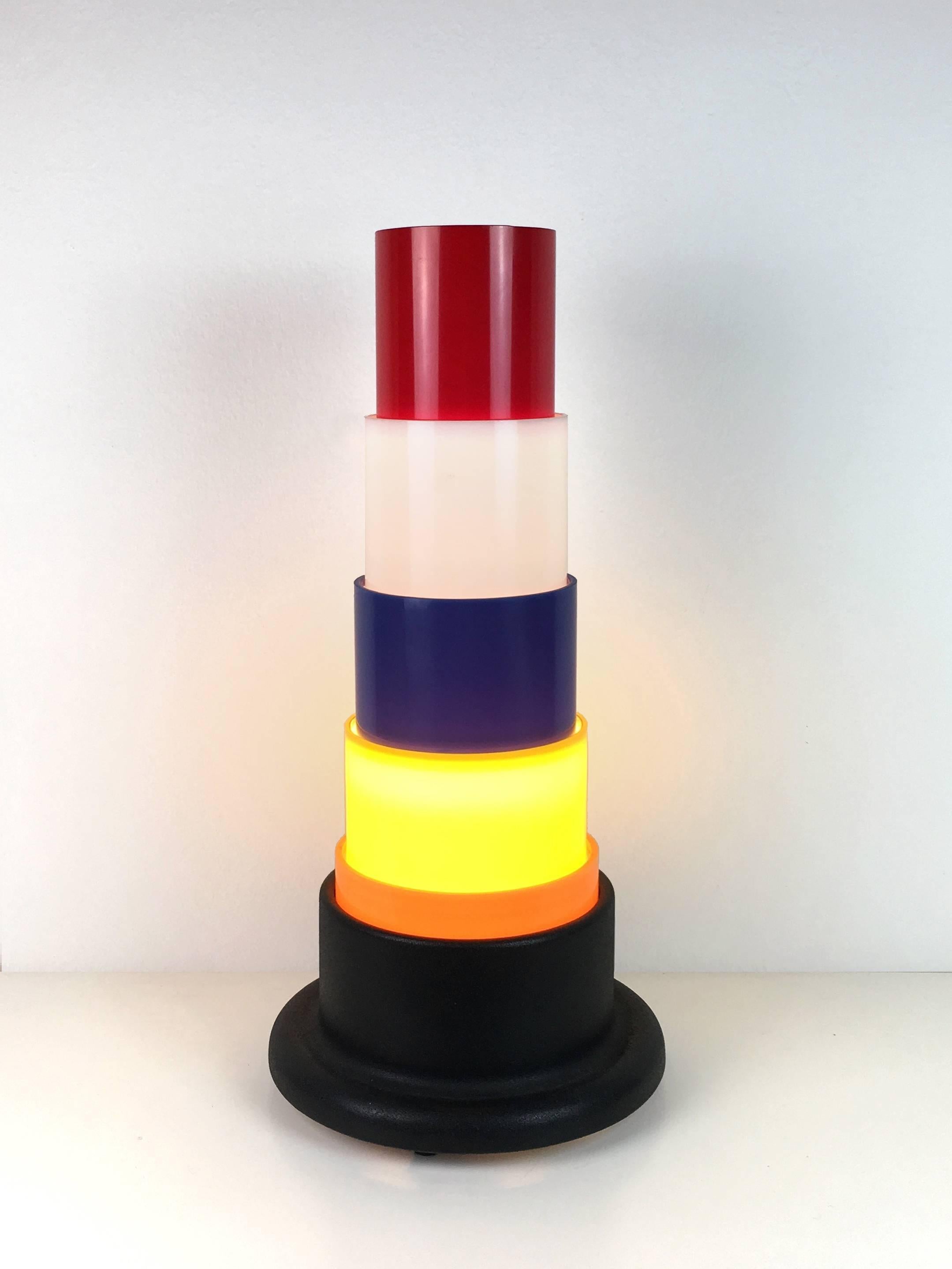 Construction of colorful plastic cylinders on the black aluminium base.
One lamp E27 max. 60W.