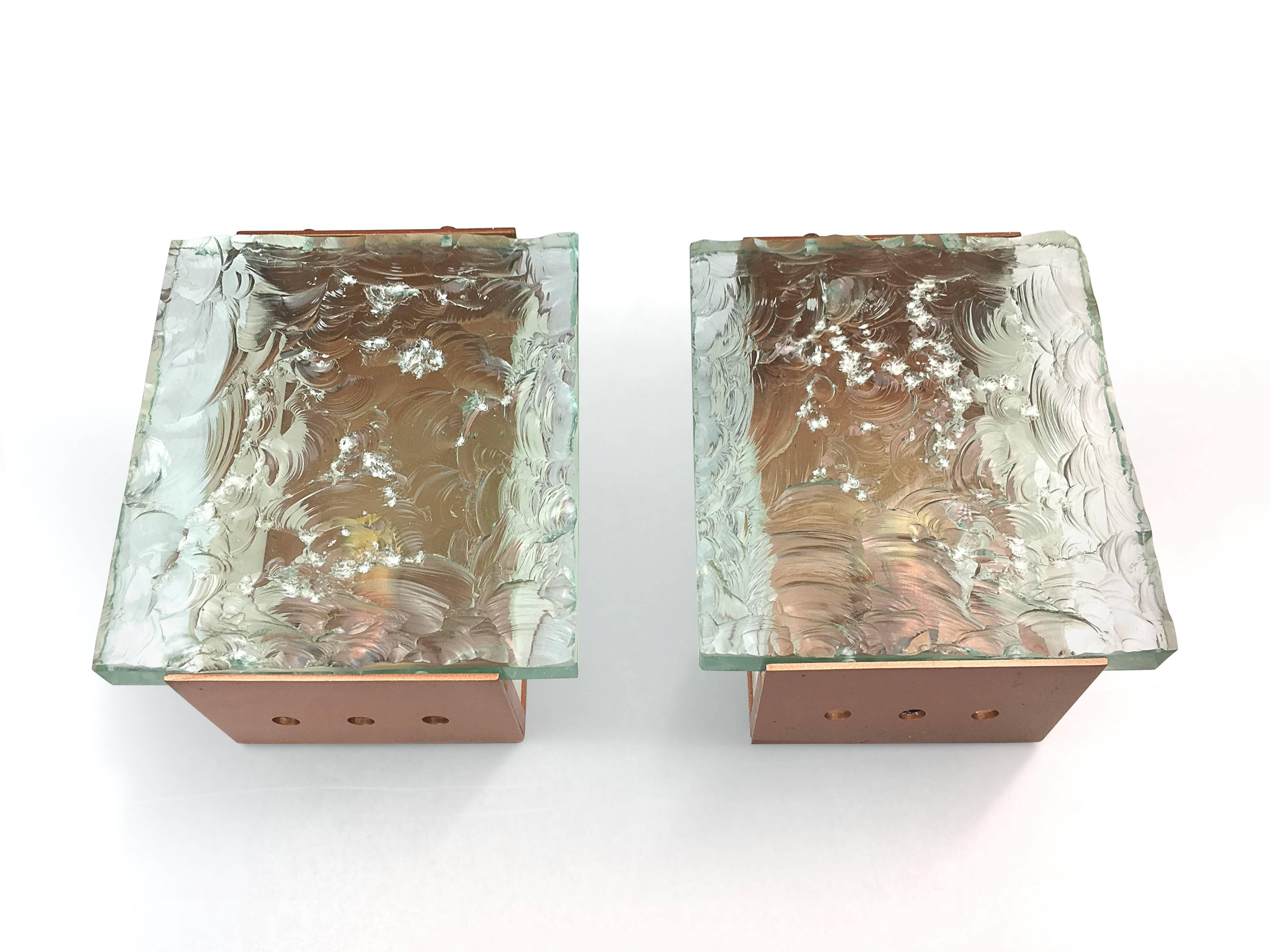 Two scones with decorative chiseled glass tops on the rectangular brass basements. Designed by Max Ingrand for Fontana Arte.