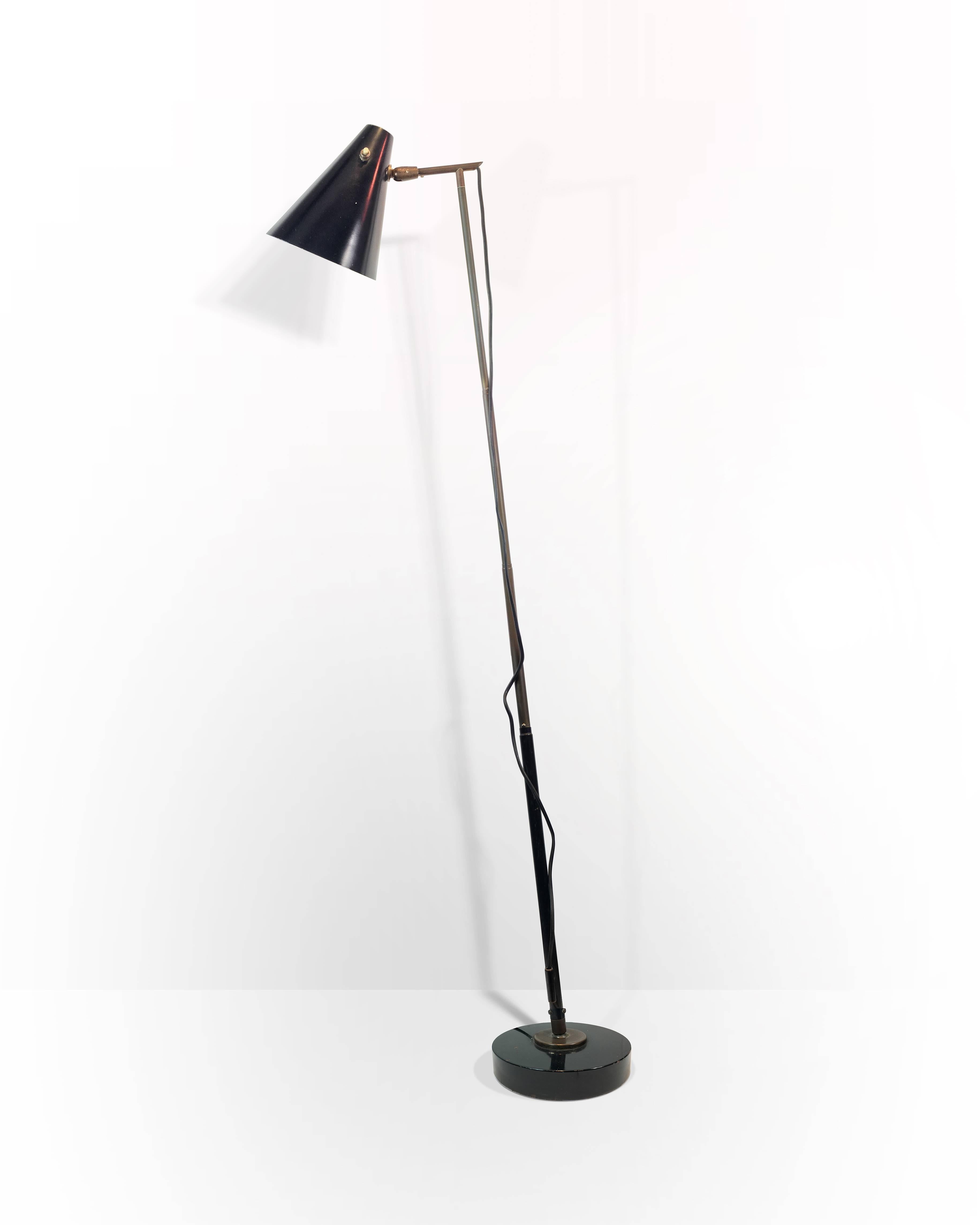 Black metal lamp with adjustable height and angle, made in metal and black enamel. Was designed for Oluce by Giuseppe Ostuni in 1950s.