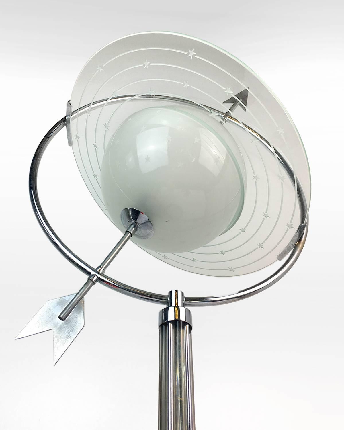 Frosted glass lamp form of the Saturn with stars pattern and metal arrow.