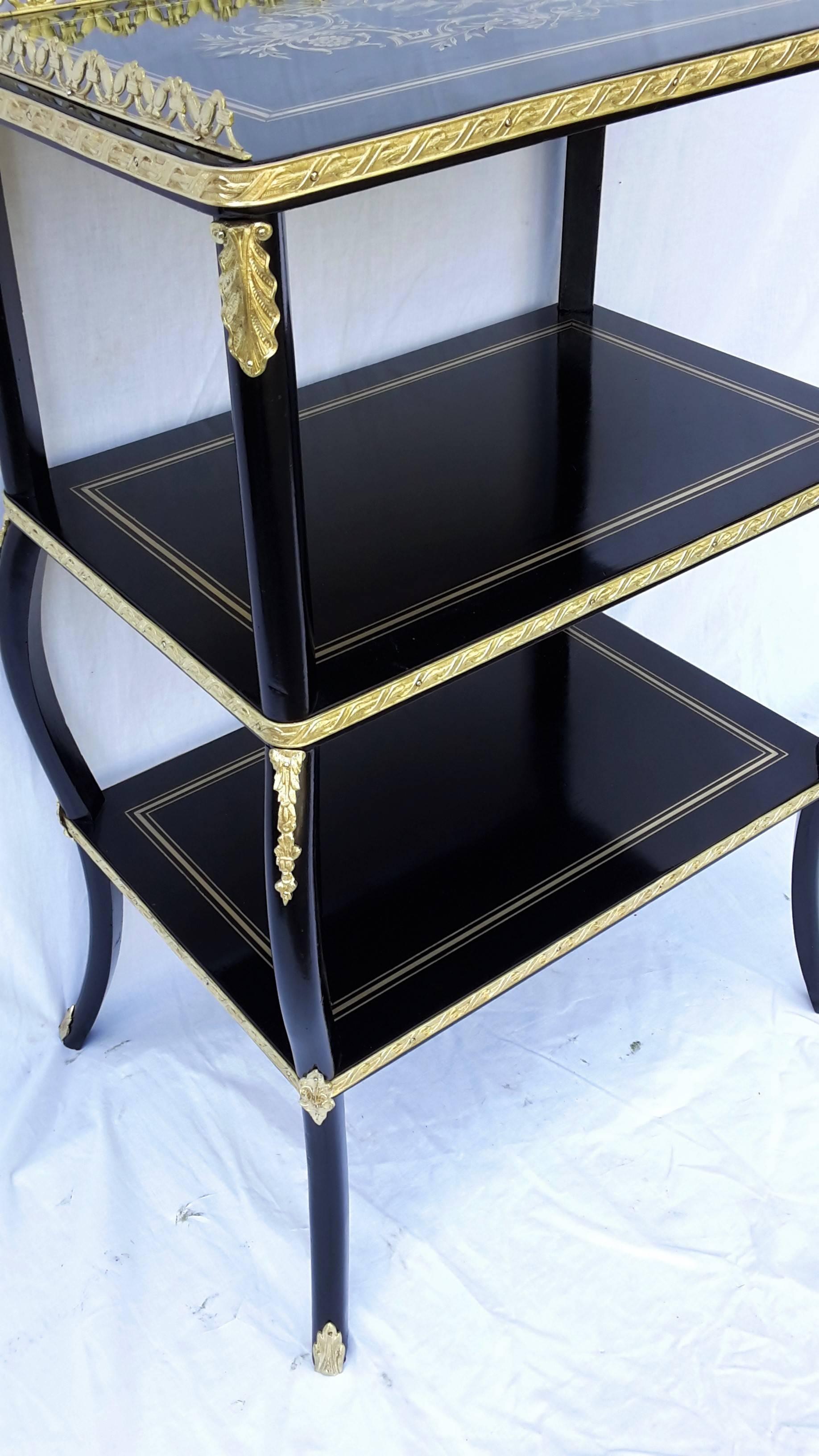Charming 19th century French, Napoleon 3 style side table with three floors, decorated in Boulle Marquetry style with brass filets and a beautiful ornamentations at the corners. Many decorations in gilt bronze in all
facades.
Napoleon 3 style,
