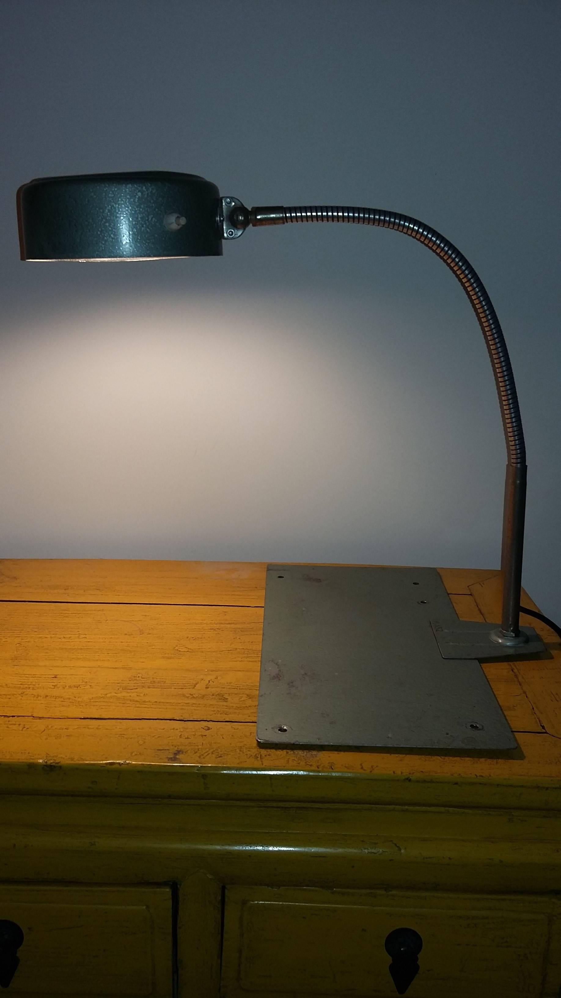 French government administration vintage industrial style metal desk lamp. The base is a metal plaque that can be fixed or not on a desk table (five holes) and A round flexible and adjustable reflector made in green color;
Numbered A 152. French