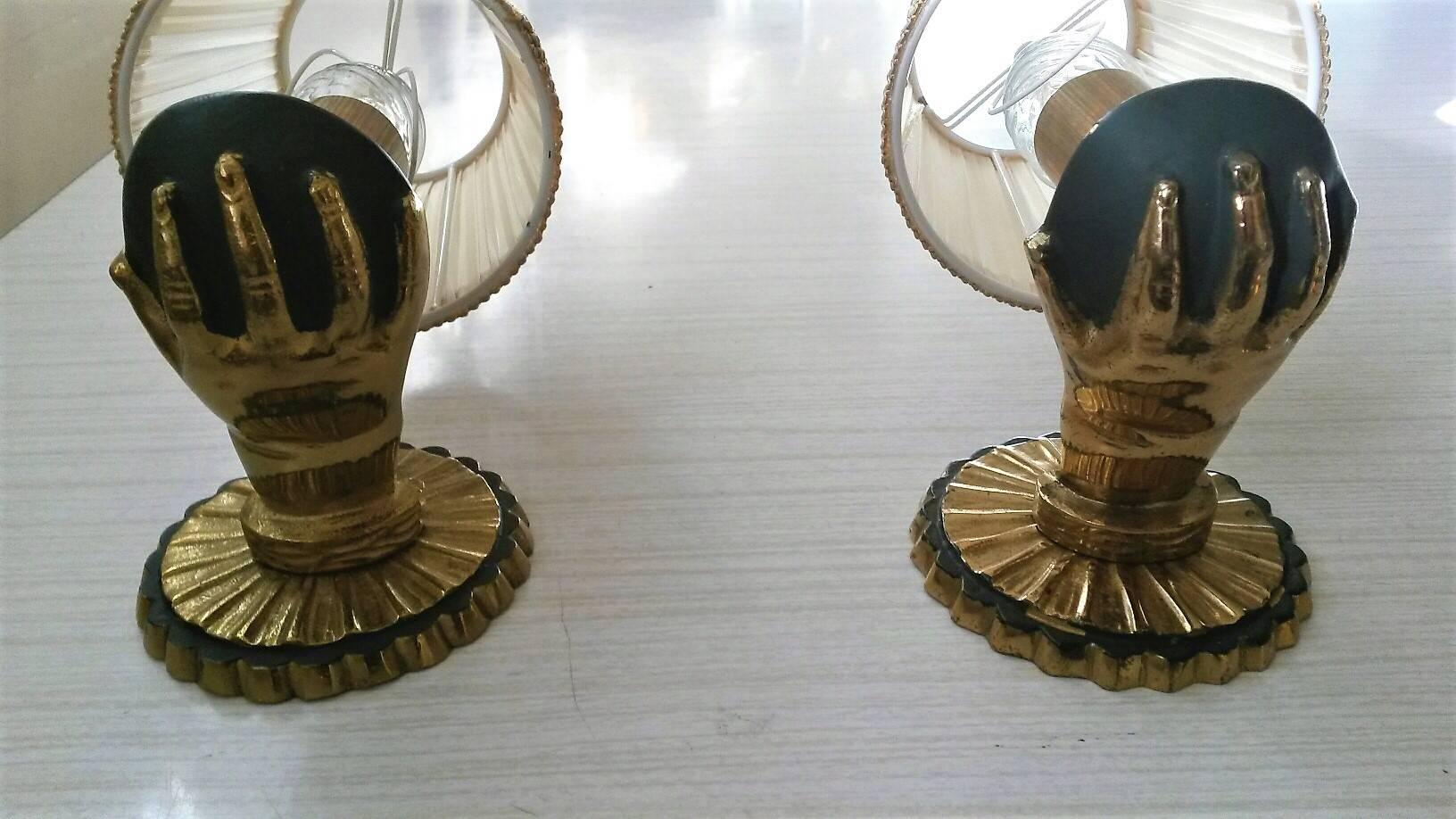 Beautiful and original pair of gilt bronze sconces and beautiful l antique green patina wth ts pleated Ivory silk lampshades , representing a Child hands des mains d'enfant in the style of maisons Bagues / Jansen. France 1950's

In an excellent