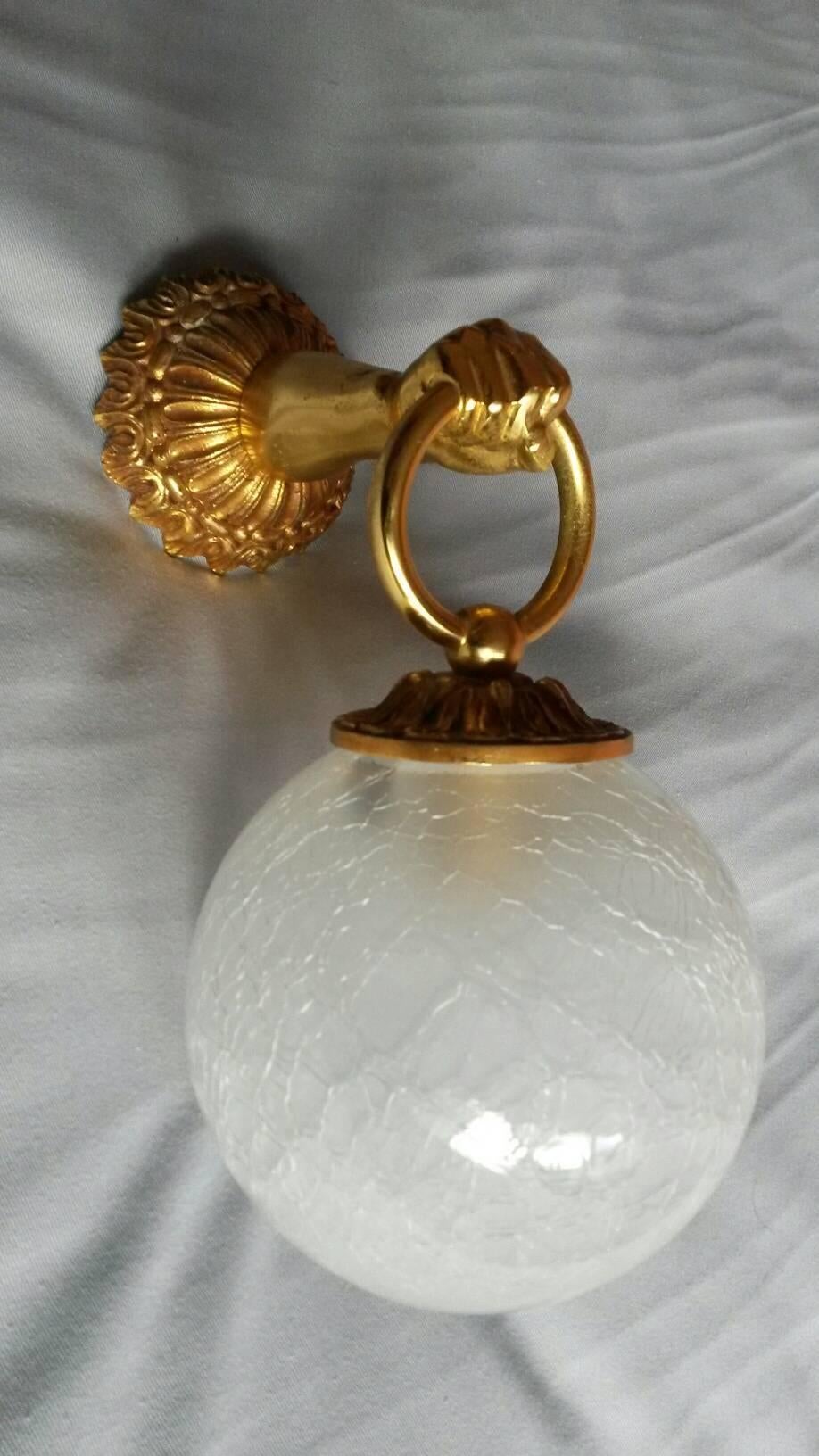  French neoclassical sconces in gilt bronze, in the style of the Maison Jansen.
One set has nice original icy cracked   and  the other set has white matte opaline globes. ( These original icy cracked style globes are very rare to find ) . You can