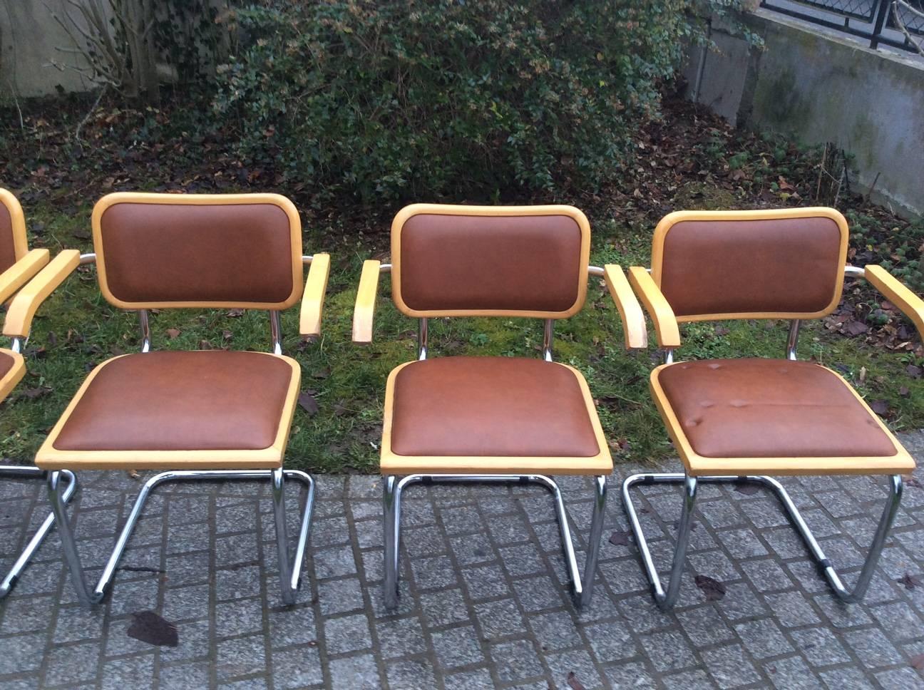 Set of six Marcel Breuer armchairs, edited by Knoll in the 1970s. Very confortable seating with ,covered in their original faux brown leather beech armrests and frames. 

The French Hungarian artist Marcel Breuer created these armchairs in 1928.