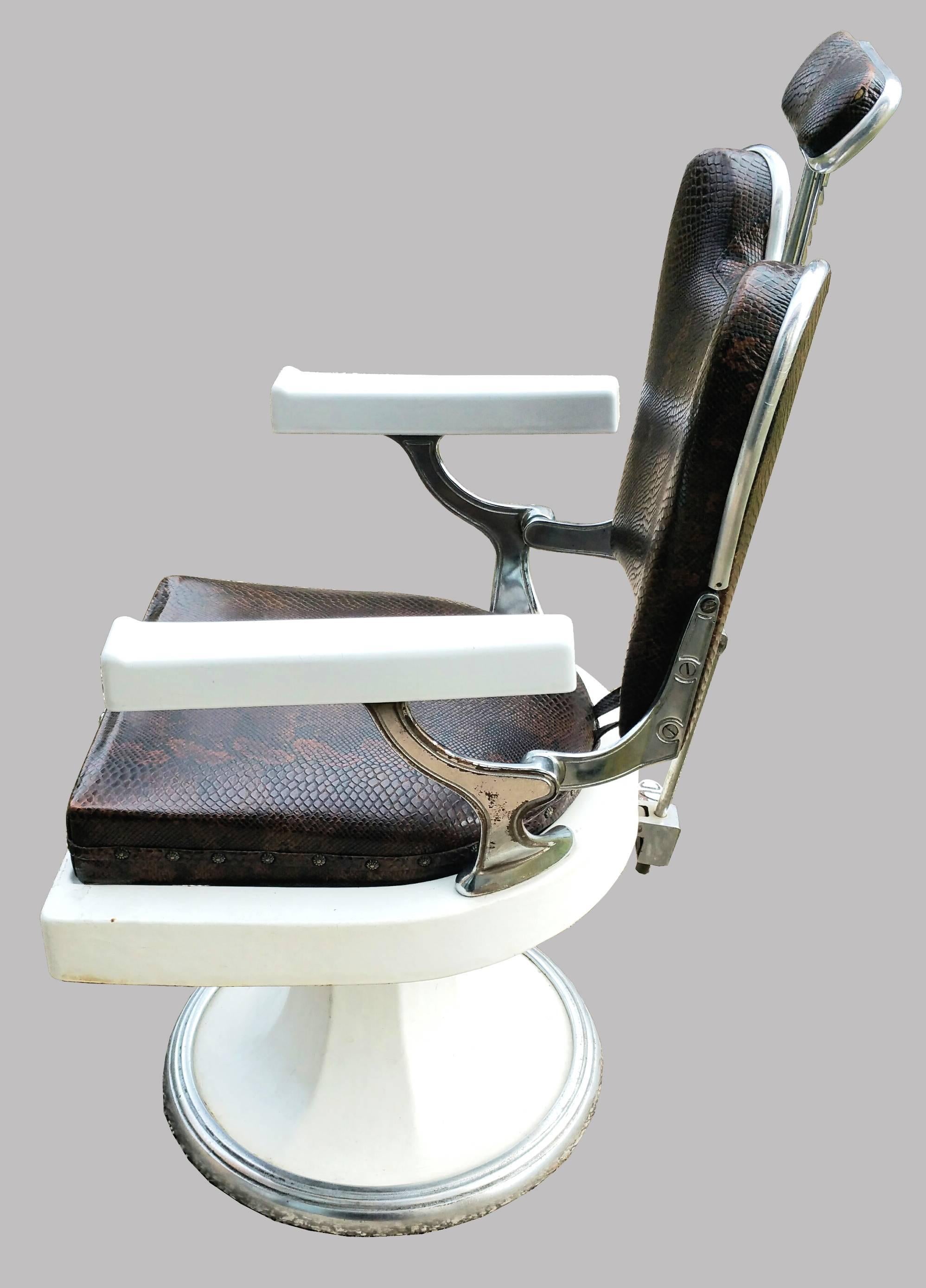 Great French vintage barber chairs - with its original and amazing brown color crocodile leather with iron cast and base in white and re-polished enamel chrome.

Chair has adjustable head rests. 

We have three chairs available. It can be sold