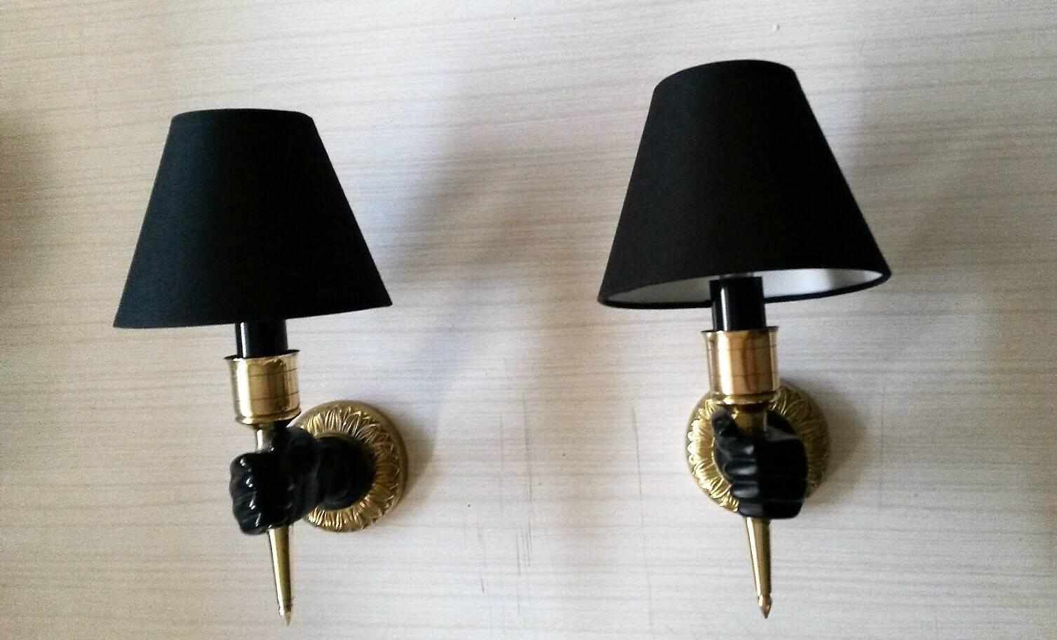 Pair of French elegant bronze and brass sconces with hands holding a golden torch by Maison Jansen.

circa 1950

Priced by pair. 
Totally rewired and in working condition.
One light per sconce.
  