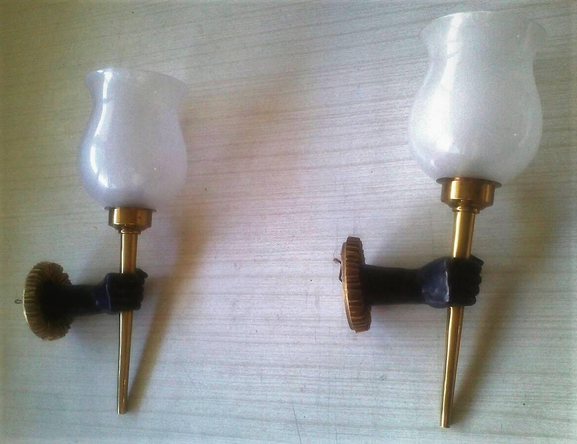 Beautiful pair of French neoclassical sconces in gilt bronze and black patina handling a torch with matte white Opaline Globes by John Devoluy.
France, 1950s
gorgeous contrast of black, white and golden colors.

Priced by pair
Wired and in