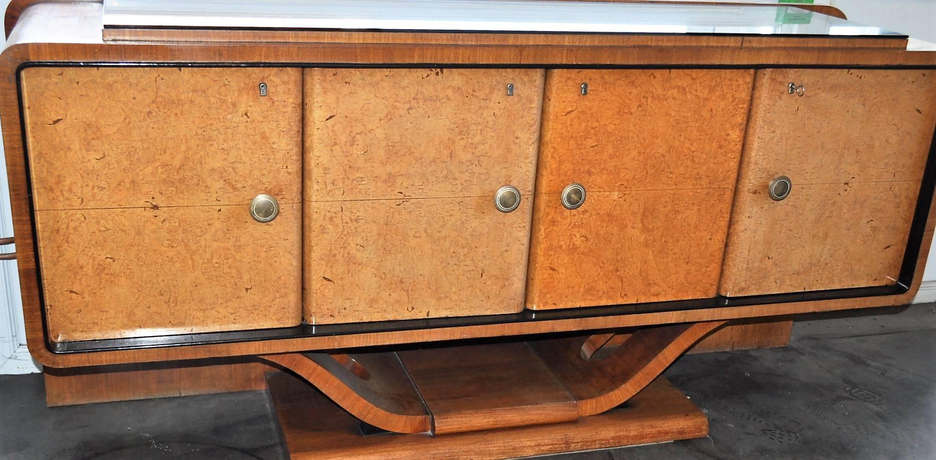 Original French complete Art Deco set, circa 1930s including : 
One rectangular dining table molded top raised on stylized lyre-shaped end supports with blackened glass cover.
Four chairs in original dark green leather.
Two sideboards credenzas