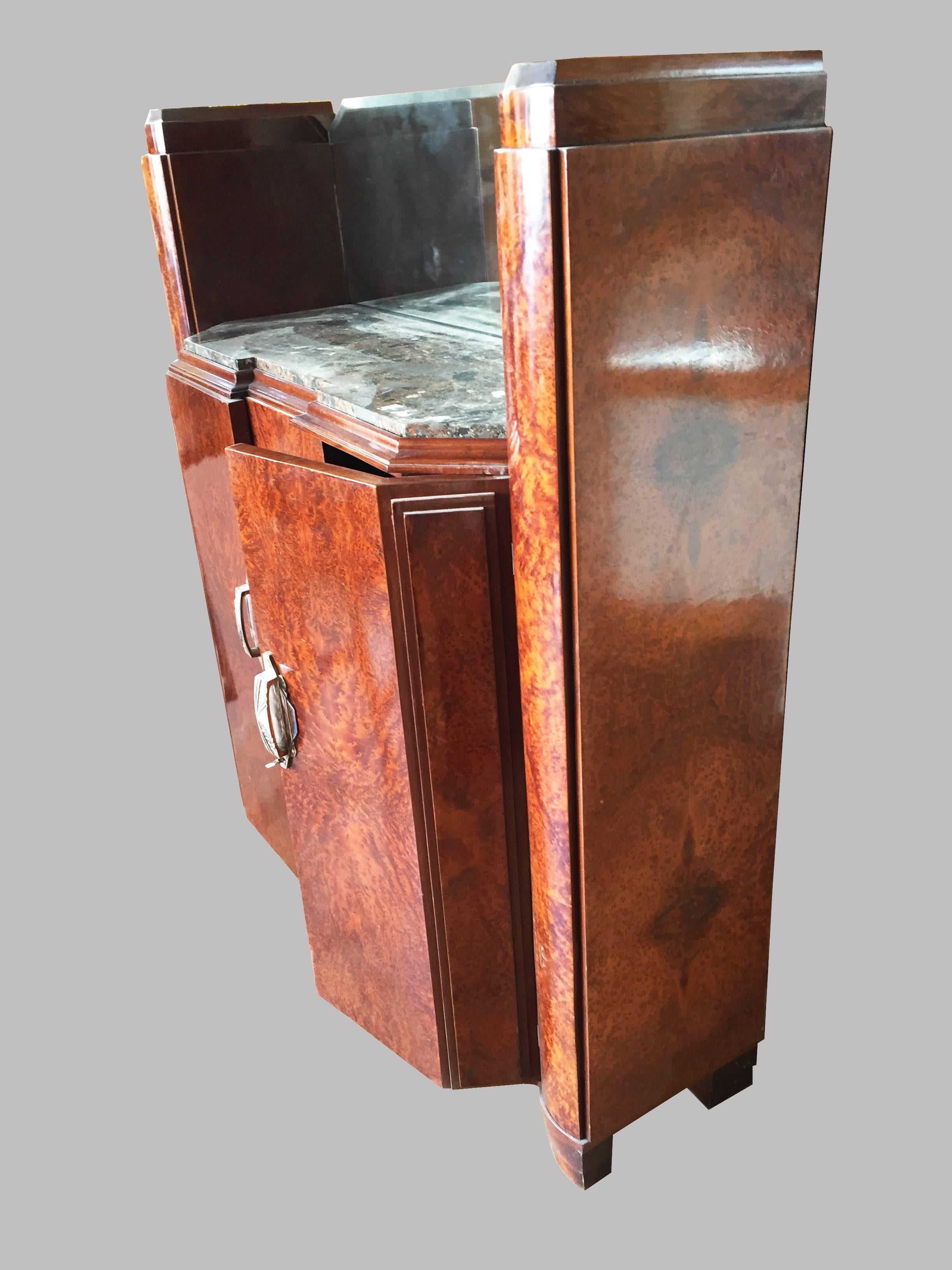 A charming, very original and unique French Art Deco varnished cabinet with beautiful and unique design with a beveled mirror in the center top of it, a mixed colors marble top and 2 doors storage. Great wood and handles, all in an excellent