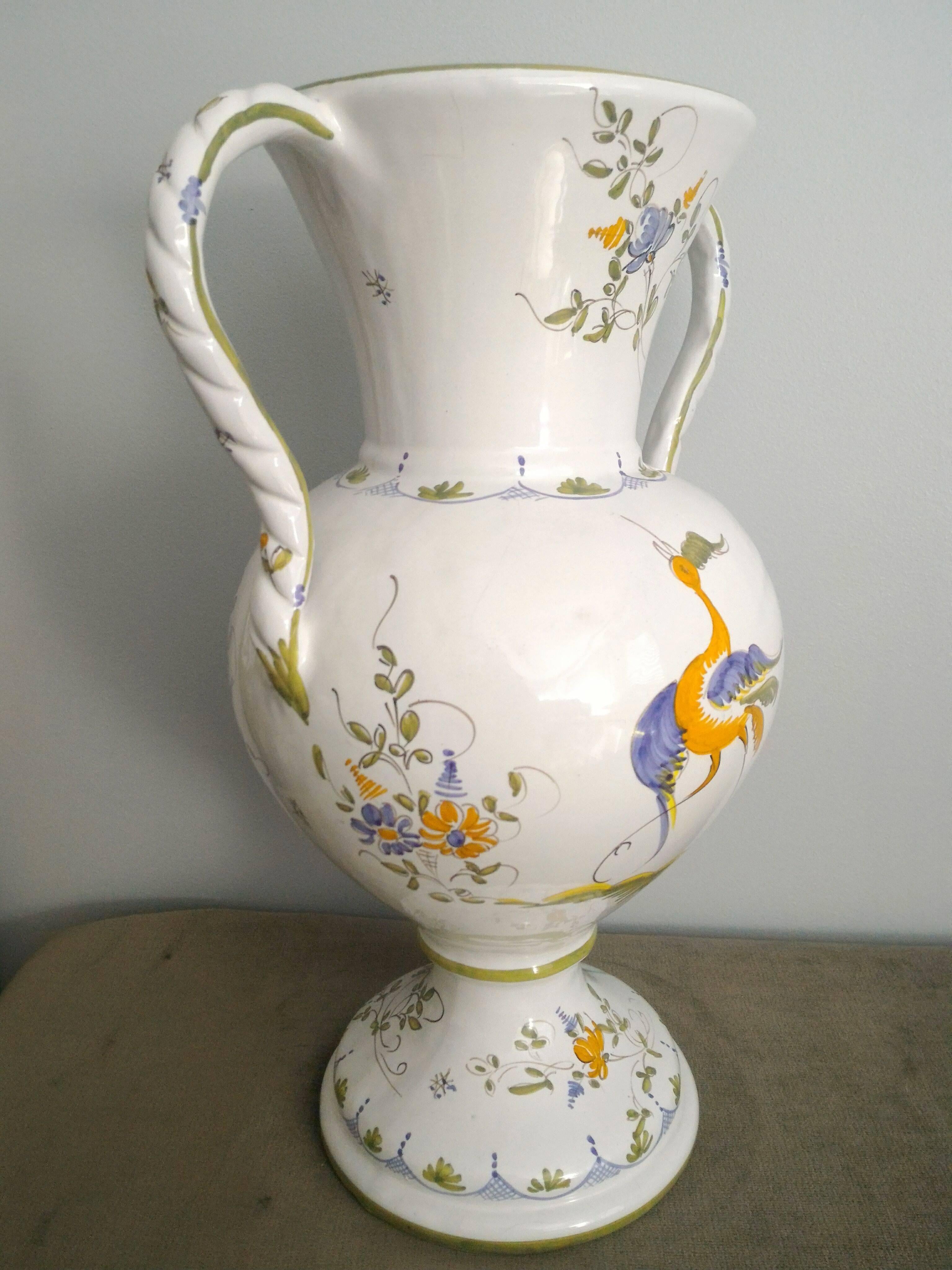 French country provincial white tall size two handles vase by Moustiers, signed D.M. Décors de Moustiers.
Lovely hand-painted Faience in a romantic spring decoration.
In a very good condition. 

About Moustiers:

The art of ceramics has