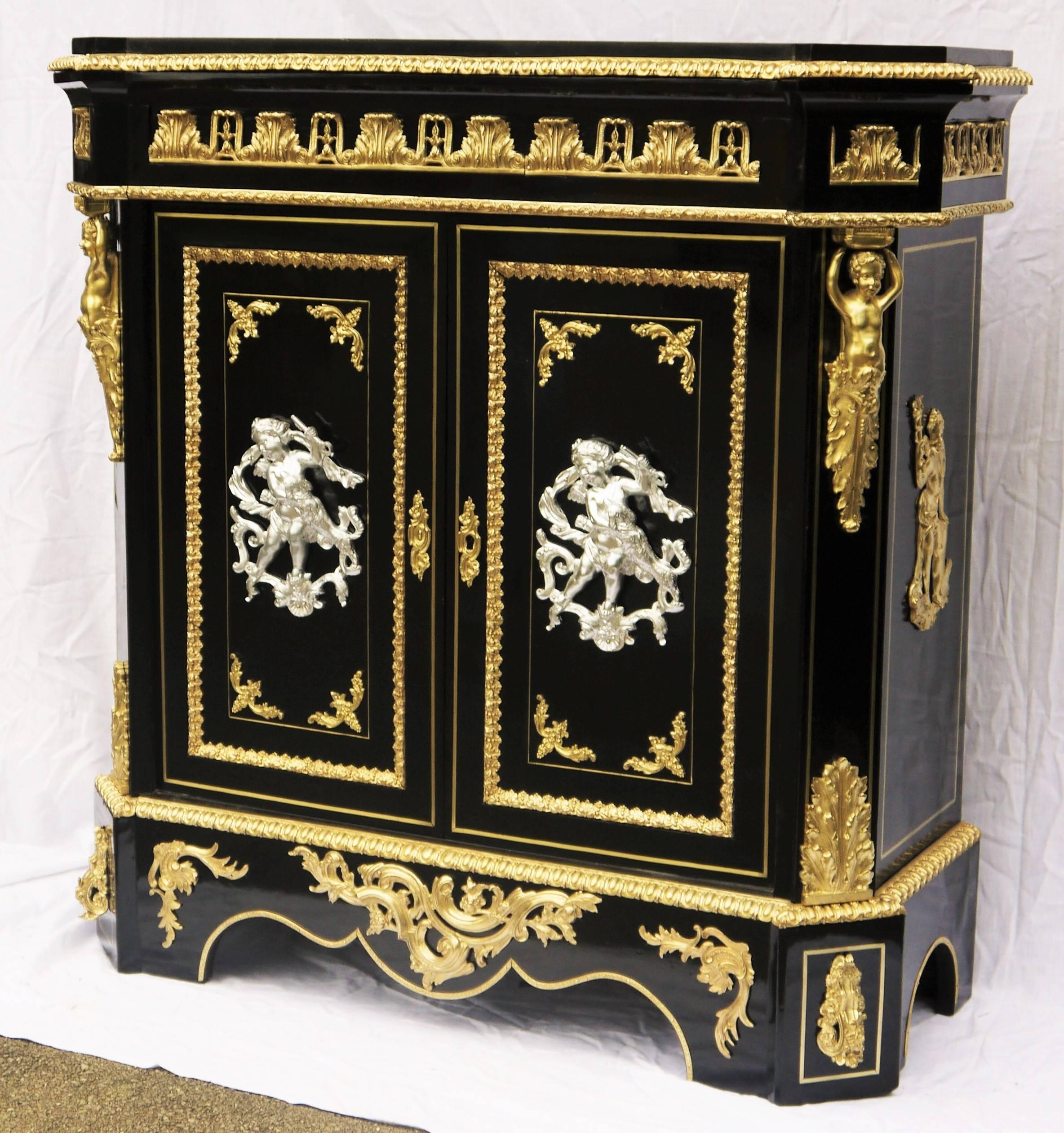 French cabinet in Boule style marquetry, two doors, ebony veneer.
Fabulous and impressive gilt bronze ornamentations, in an excellent quality incredible decoration: more than 15 kilos of Gilt Bronze in total!

Gorgeous silver bronze putti at the