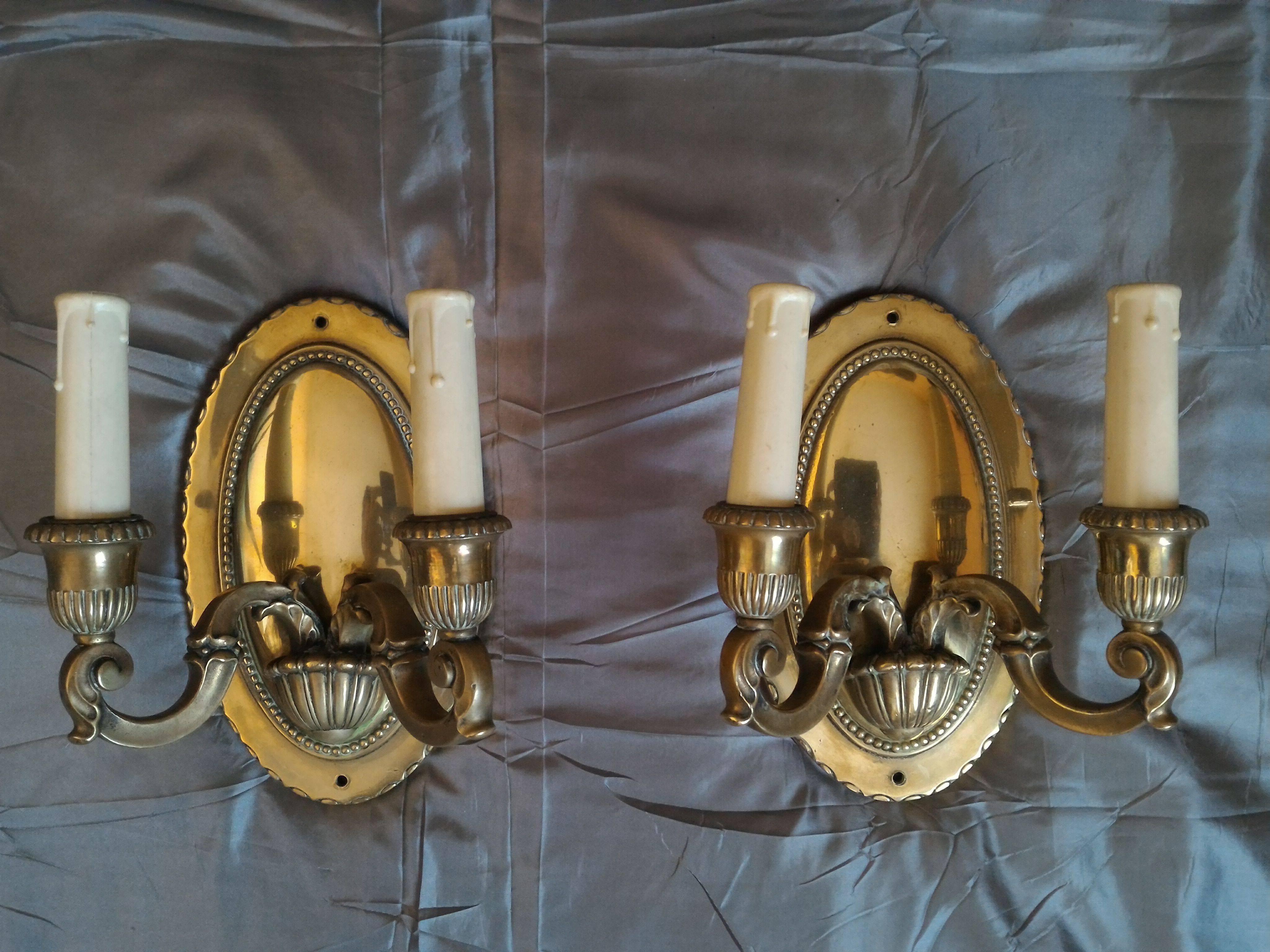Pair of refined French gilt bronze two-arm sconces, bronze mirror reflection style that creates a gorgeous atmosphere.