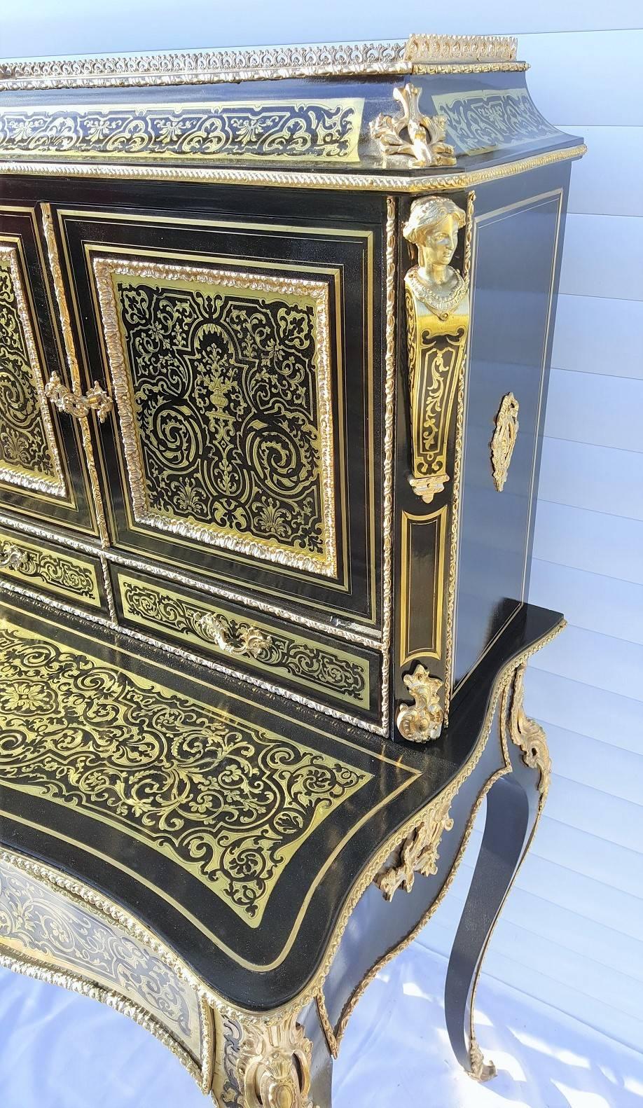 Precious Napoleon III style secretary desk in boule marquetry and gilt bronze ornamentations. Beautiful caryatids at the top corners, several drawers. 

France, circa 1870

Totally restored by our specialist team and in excellent condition.