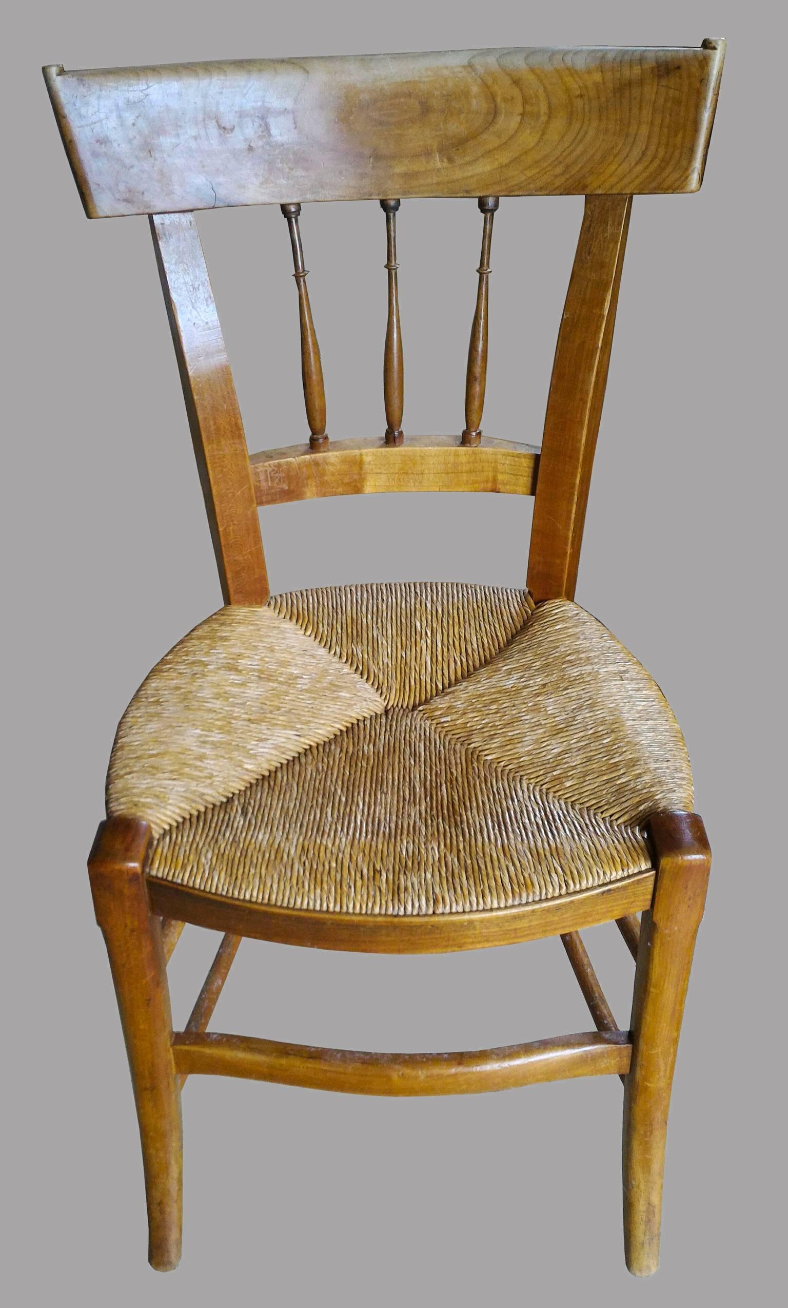 Set of eight dining room chairs in a country French Provincial style, made in solid cherrywood, beautiful original patina and lovely rush solid seats.
Beautiful details as the 3 columns and the top corners. These precise models with a sophisticated