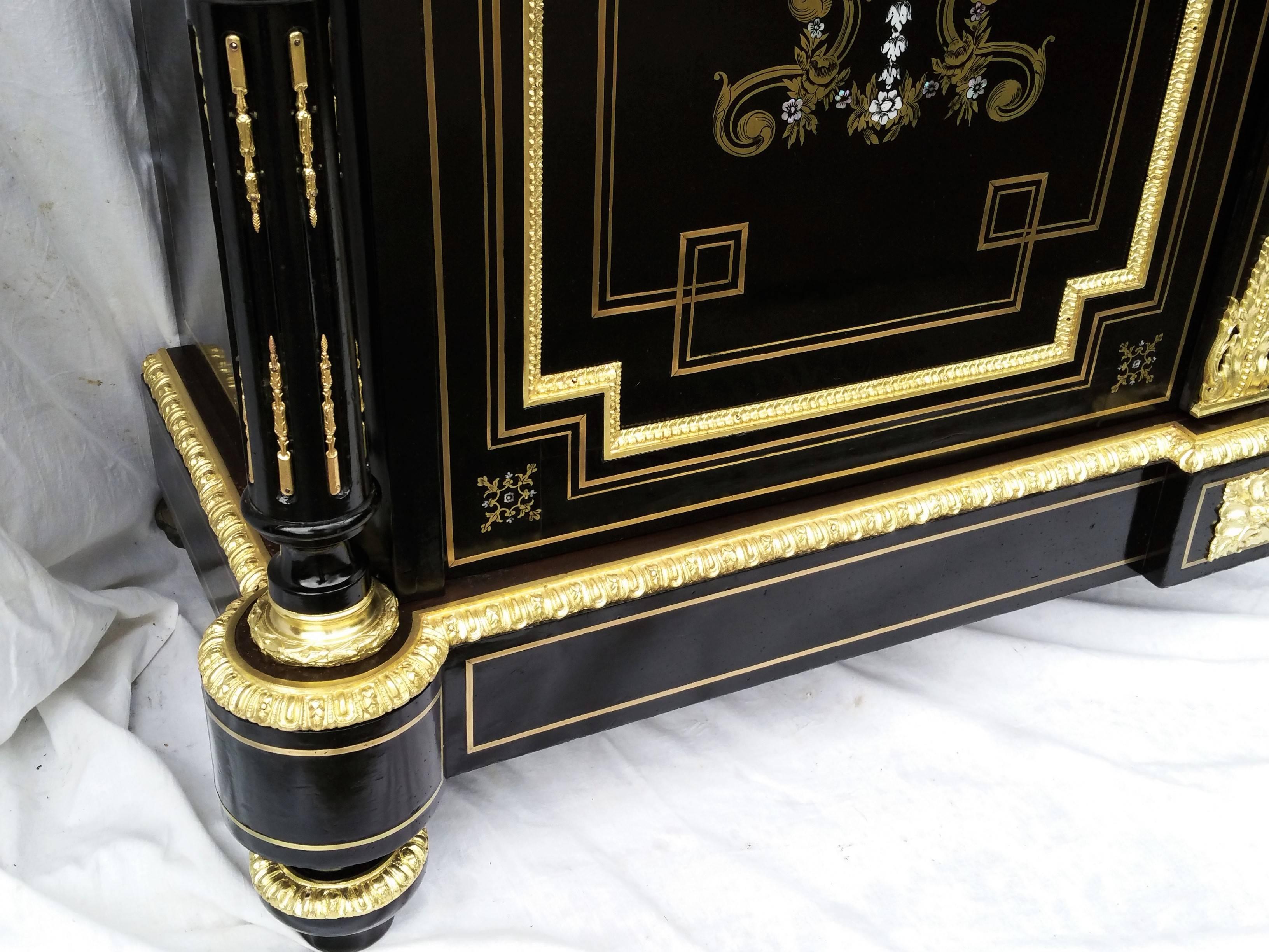 Gorgeous cabinet buffet two doors with detached columns .Boulle style marquetry with brass, bones and mother-of-pearl inlaid even in the middle cross that is really rare to find.
Beautiful ornamentations in gilt bronze, Carrara marble in excellent