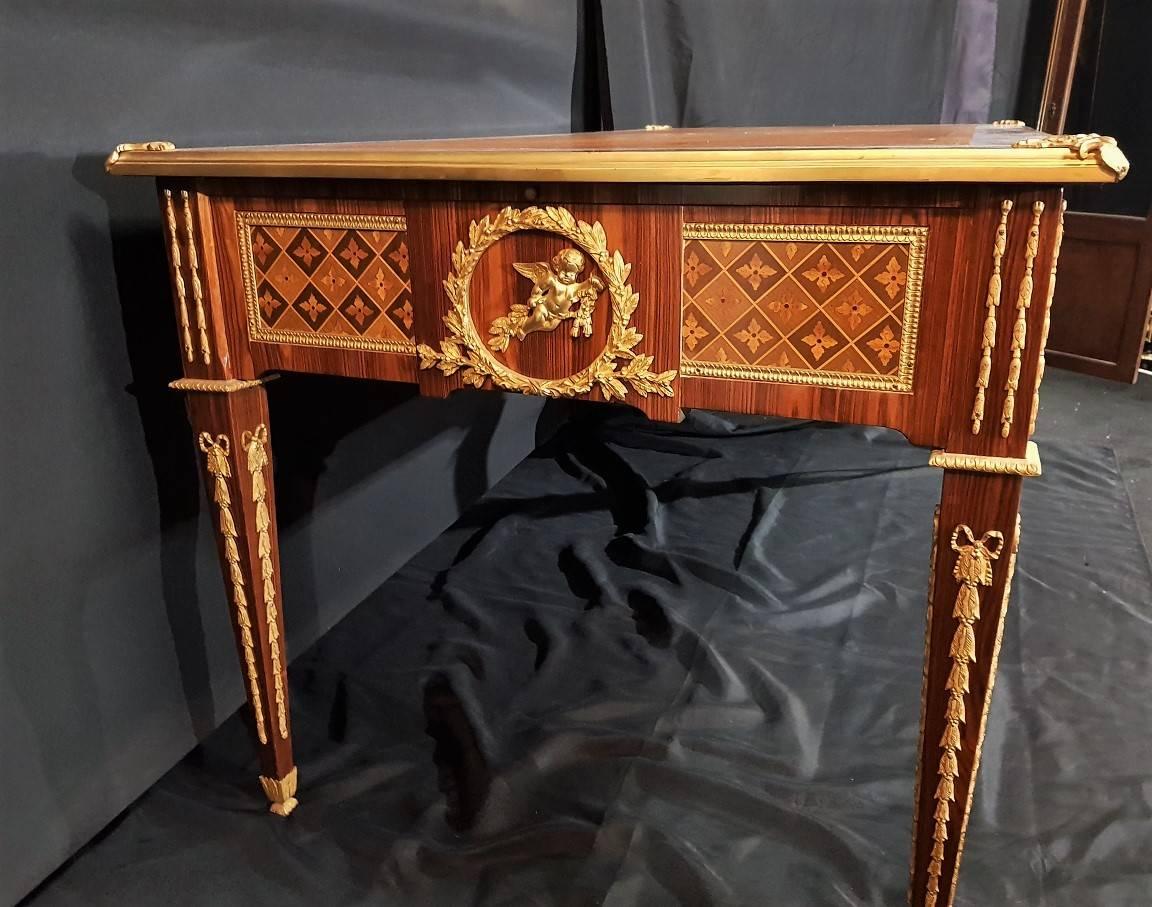 Stunning French big size minister desk writing table in Louis XV style. Two drawers.
Richly decorated with gilt bronze ornamentations and geometric style marquetry from fruitwood trees.
The top is covered by a fine new leather with beautiful gold
