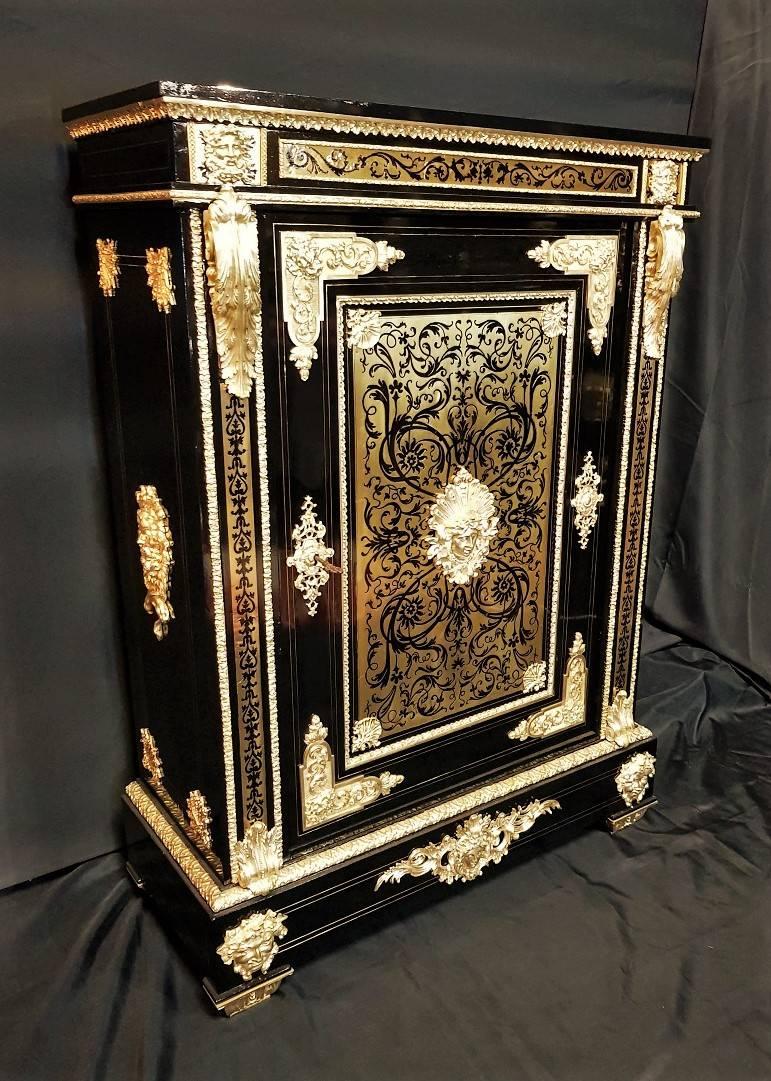 Impressive and rare big cabinet or a short armoire in Boulle Marquetry style with brass and ebony inlaid and gilt bronze ornamentations
Very important and exceptional ornamentations in gilt bronze with the symbol of Louis XIV, King of France, known