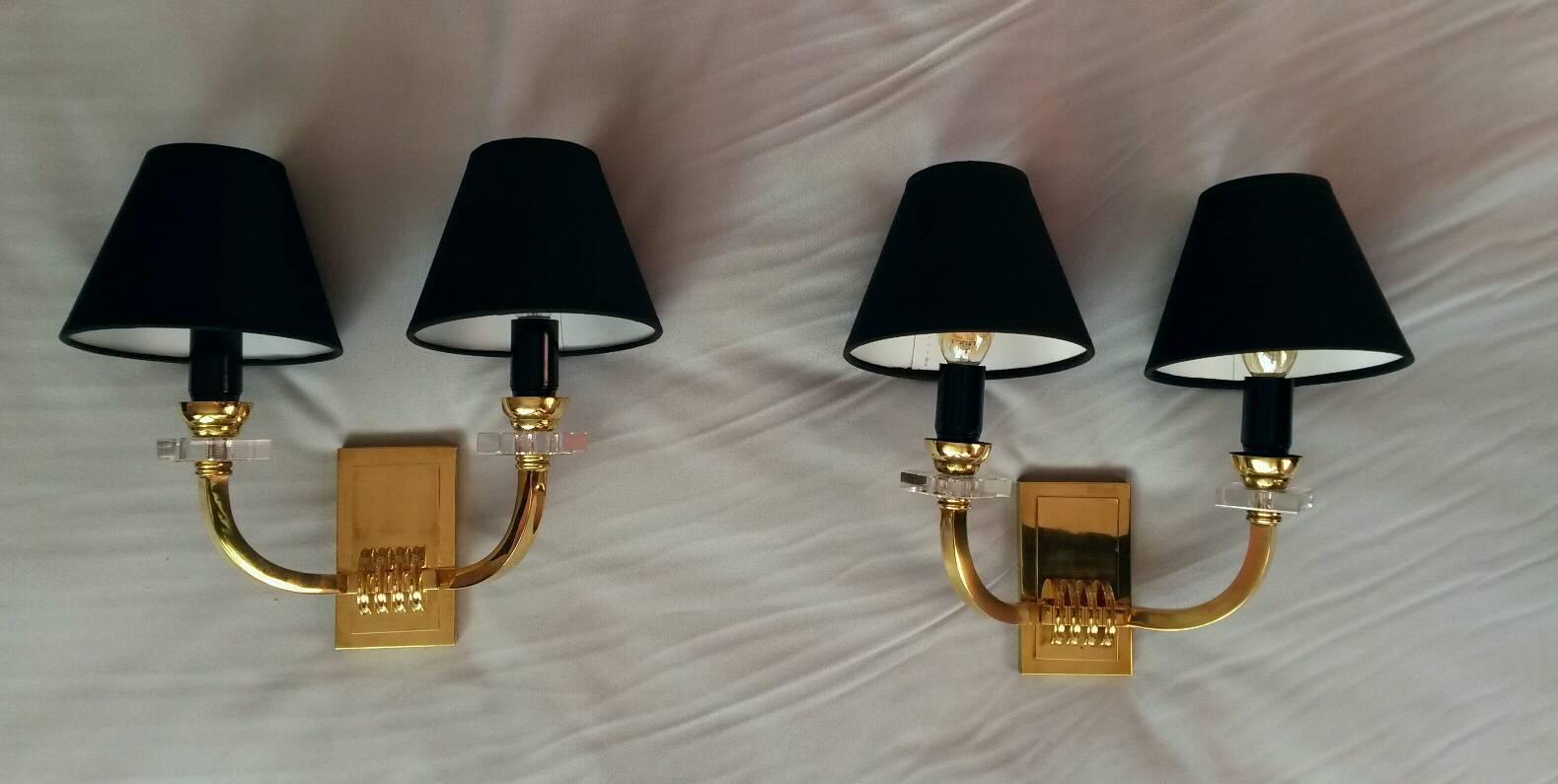 Very elegant set of two pairs in gilt bronze and glass wall sconces in the French neoclassical style of the 1950s by Jacques Adnet.
The sconces are in very good condition, new wired and suitable for US standards.
New black Cotton shades.
40 watts