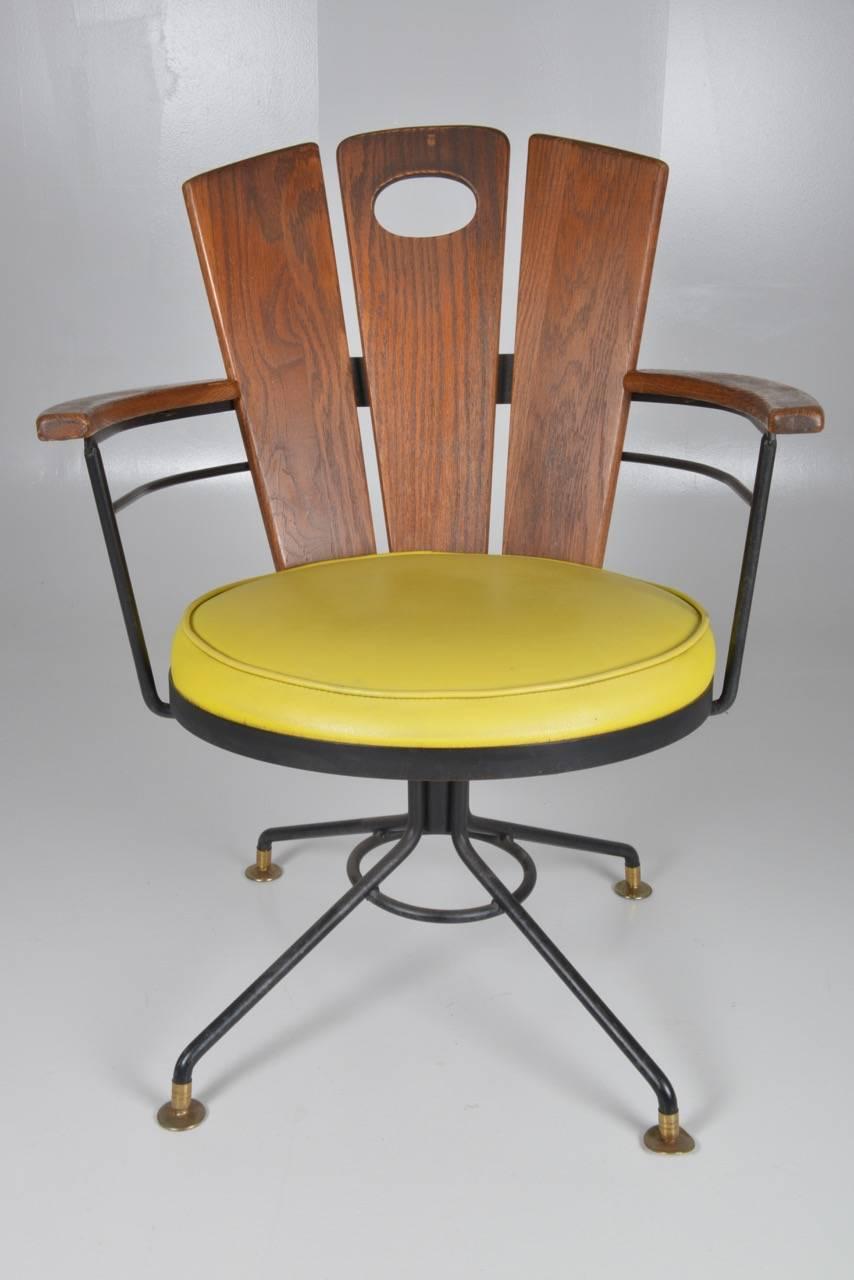 Pair of American oak Swivel chairs with bright yellow leather seat.