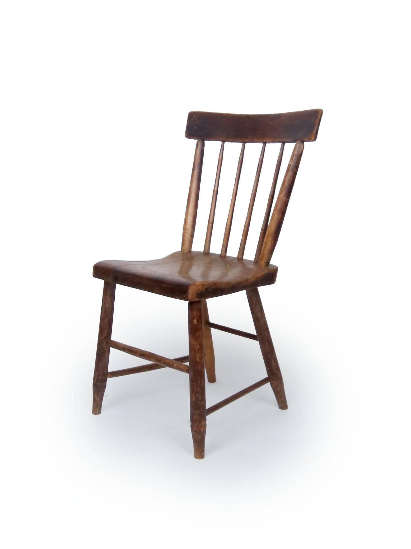 An handsome rod back Windsor chair. Splats turned with bamboo hip detail. Hickory and pine with solid plank seats, American, circa 1830.