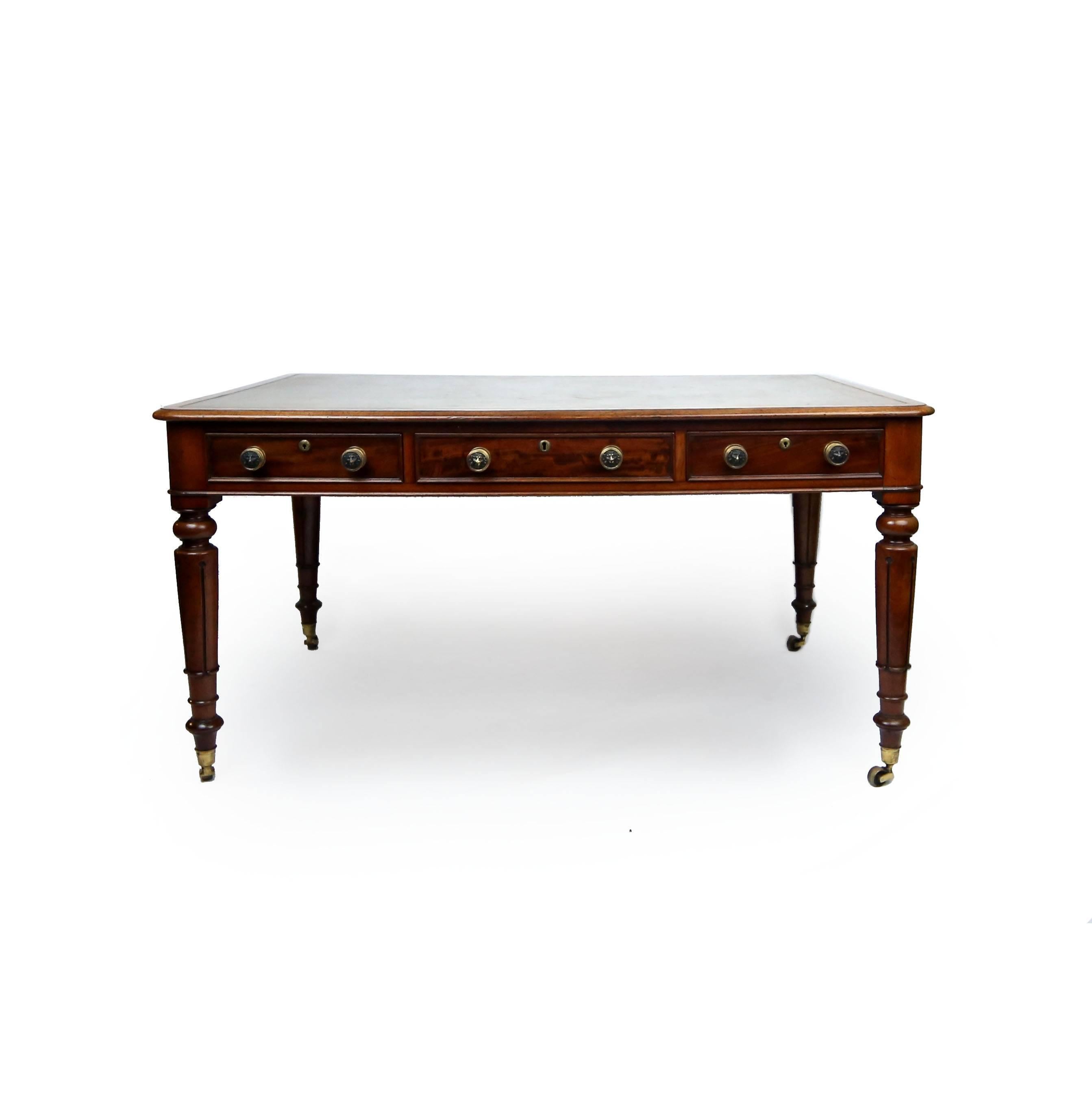 Astounding William IV partners desk in mahogany, with three frieze drawers to each side. Fine original gilt brass lions head pulls and antique olive tooled leather work surface. Turned tapering legs terminating in original castors. Gillows of