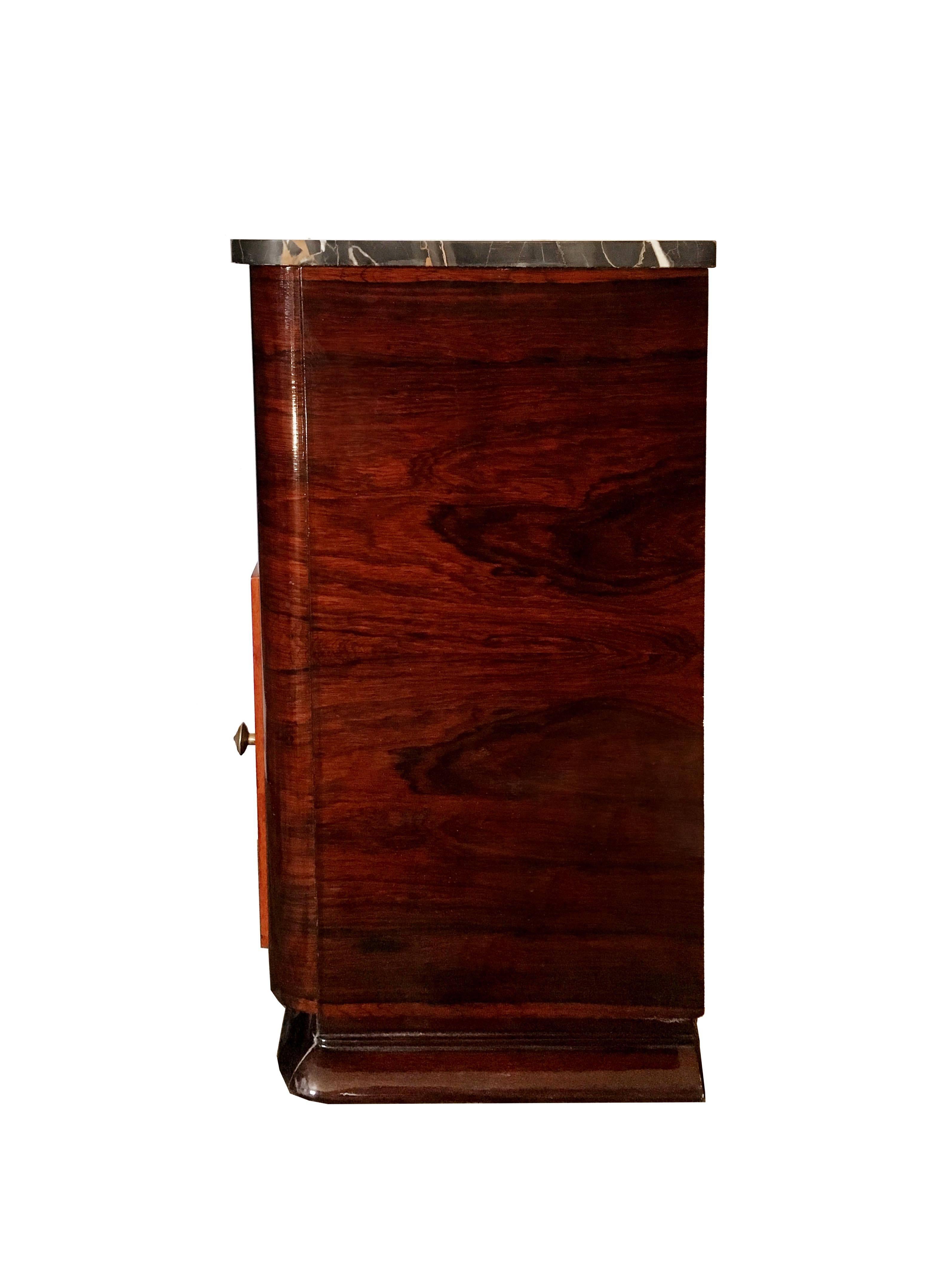 Beautiful cabinet in solid mahogany and rich rosewood veneer. The case contains to drawers, and a door opens to a larger storage space below. Original brass pulls and marble top, which is a stunning cut of thick 