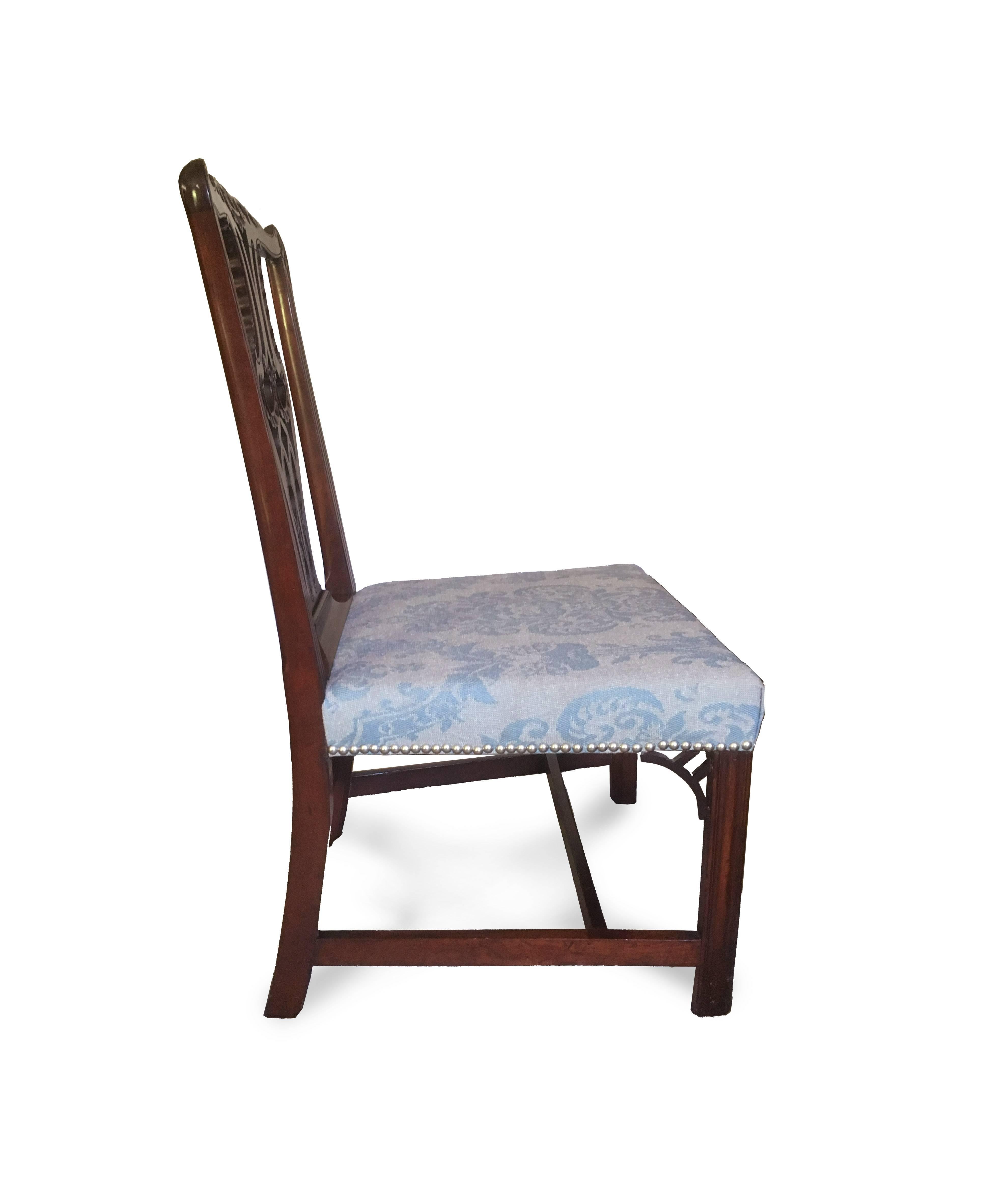 A very fine Chippendale side chair with excellent splat carving featuring fluting, acanthus, Baroque Cs, and Gothic lancet arches. The marlborough legs with molded profile support pierced Gothic brackets and over rail-stuffed seat. The cotton fabric