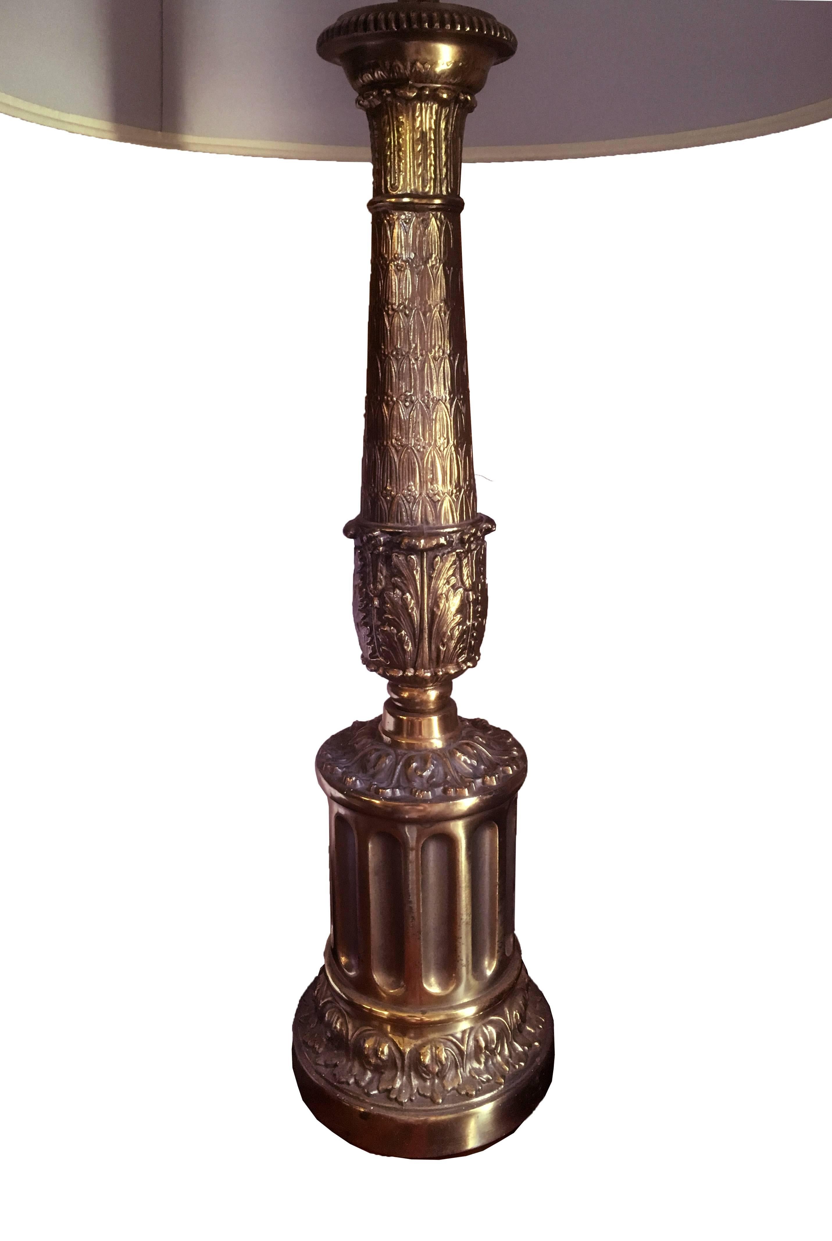 A finely detailed lamp, a round plinth rests of a fluted cylinder and a Roman acanthus balustrade supports a single light. The round shade has a subtle purple cast, United States, circa 1950.