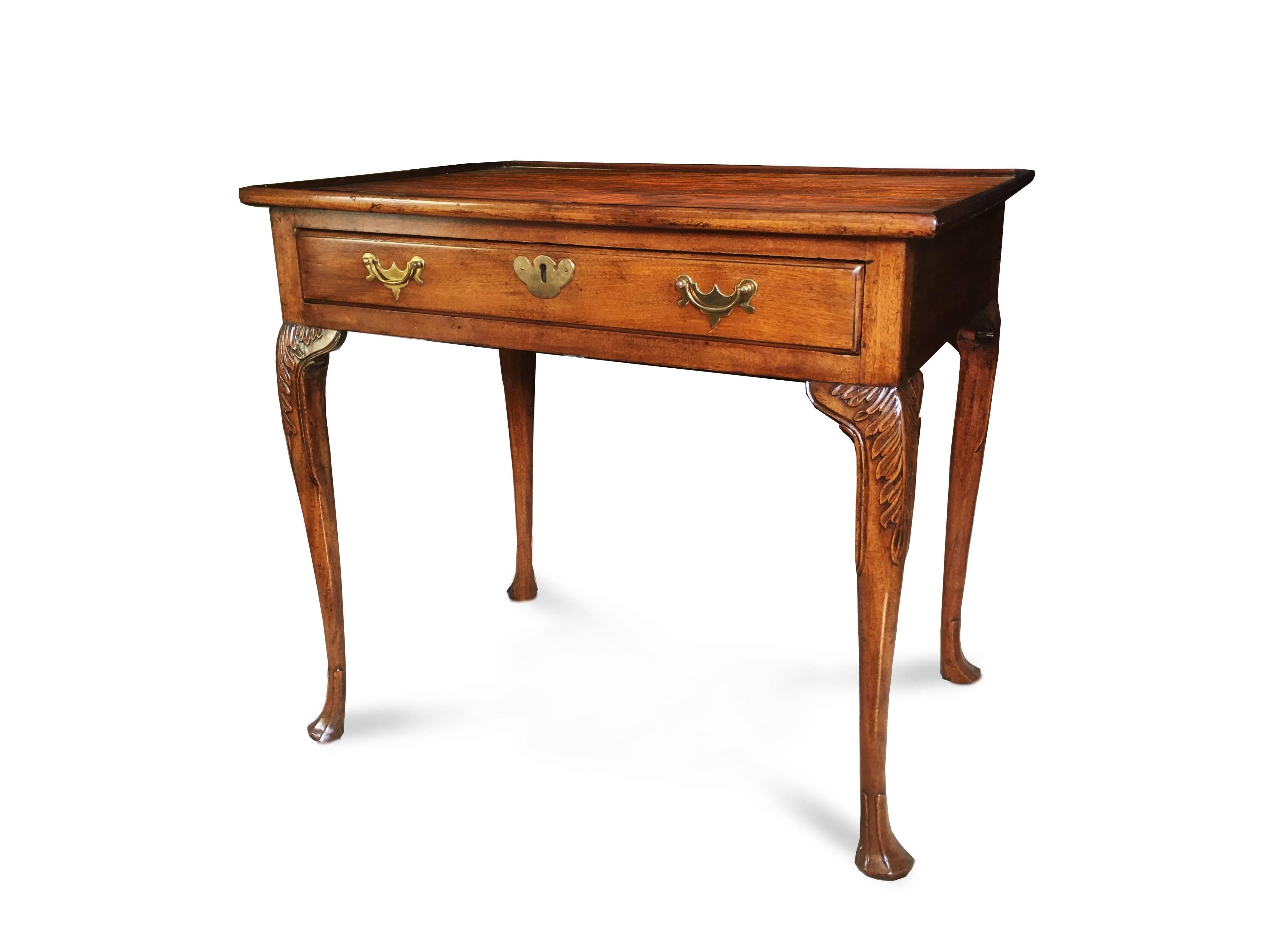 Gorgeous mahogany George II mahogany tea or silver table with tray top and frieze drawer. The slender elegant cabriole legs bear acanthus knee carving and terminate in delicate trifid feet, Ireland, circa 1760.