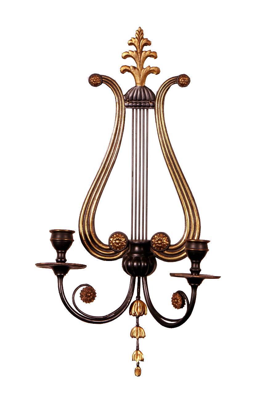 A lovely pair of neoclassical European black lacquer painted brass wall-mounted lights with harp-shaped back featuring rosettes, fluted sides, and acanthus finials. A beautifully sinuous Adamesque design. France, circa 1940.