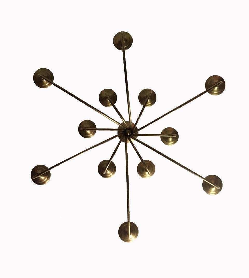 Elegant, large midcentury branched chandelier or pendant light solid brass frame with 12 lights in two tiers of six extending from a bound bundle collared by large brass discs that gently separate into oblique curved arms. A modern interpretation of