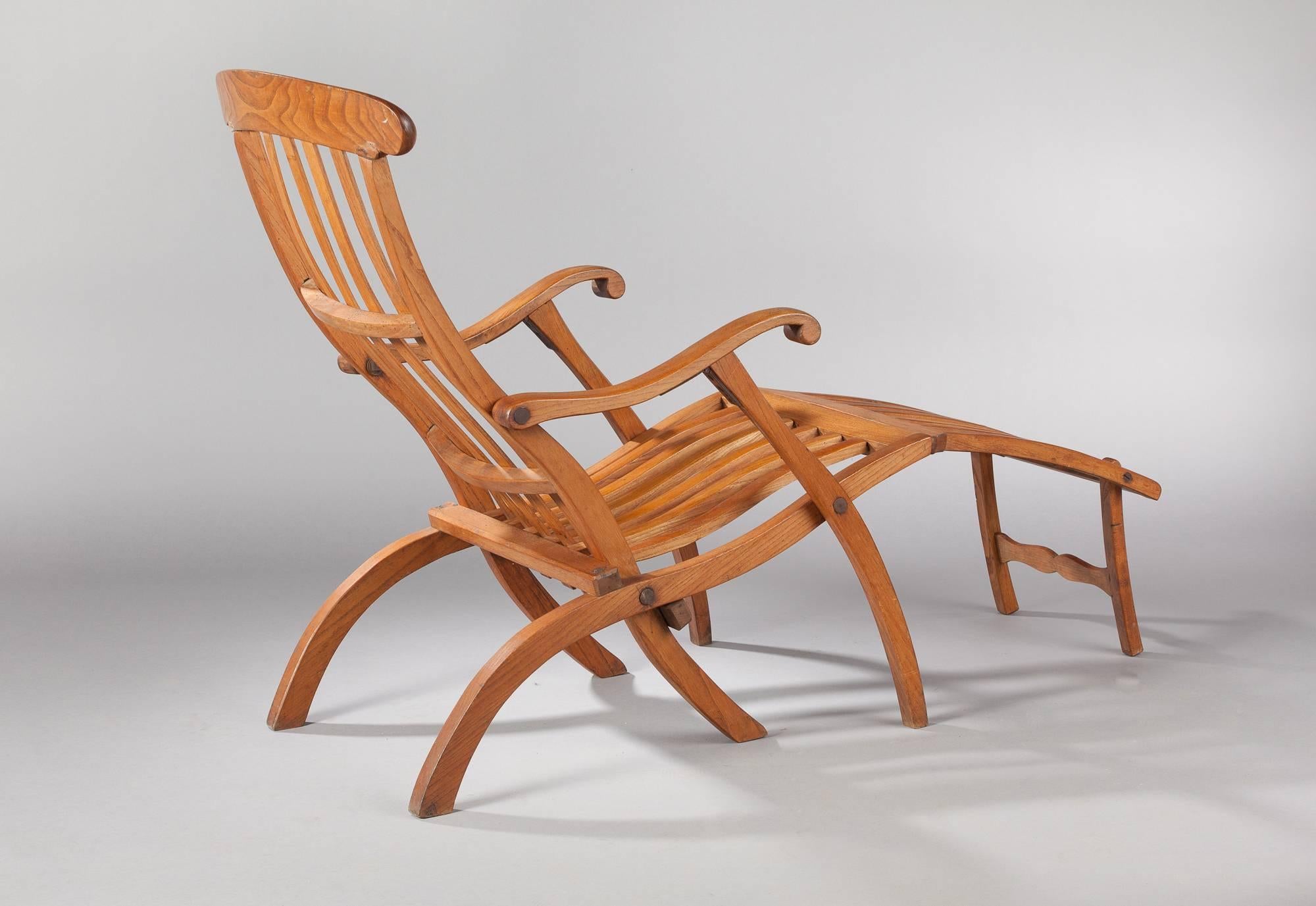An elegant Art Deco teak wood lounge chair named "Transat" which came from a French ocean liner. You can see similar chairs standing on liner decks in retro photos.