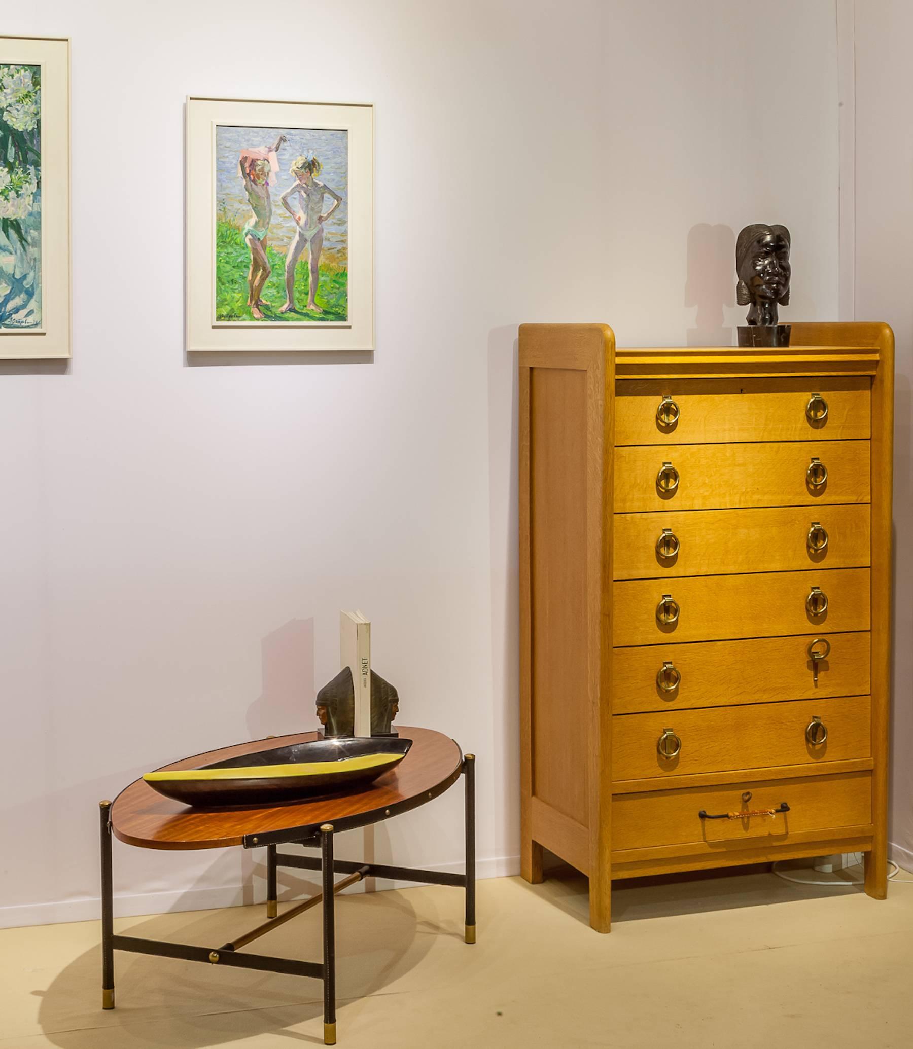 Mid-Century chest of drawers in solid exotic wood opening by seven drawers in the style of Jacques Adnet (1901-1984).