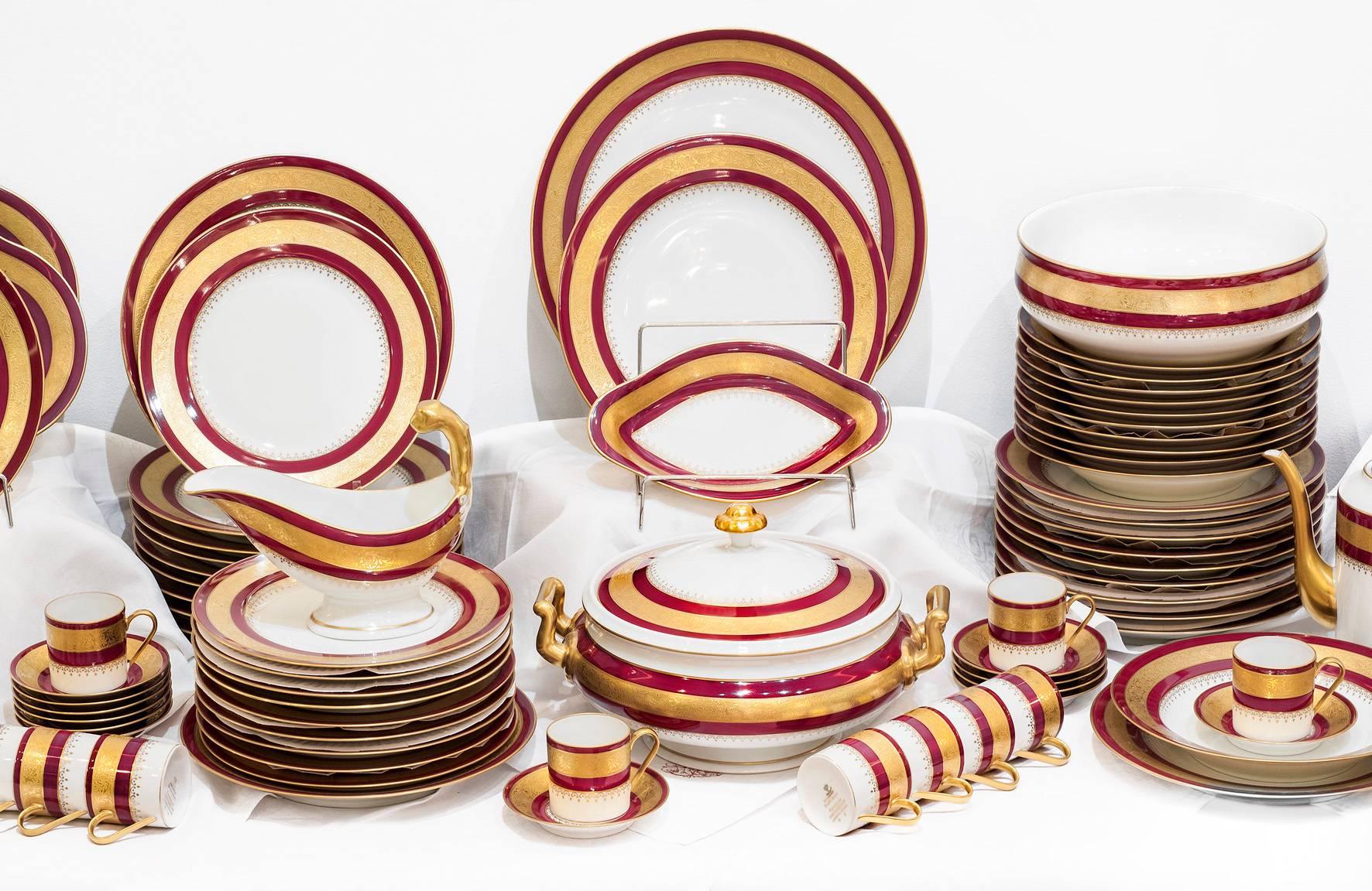 A very elegant 83 pieces French Limoges table service completed with its coffee service in top conditions for 12 people with additional pieces. 
White brilliant and red porcelain decorated with double encrusted Fine gold. 

24 plates 
12 soup