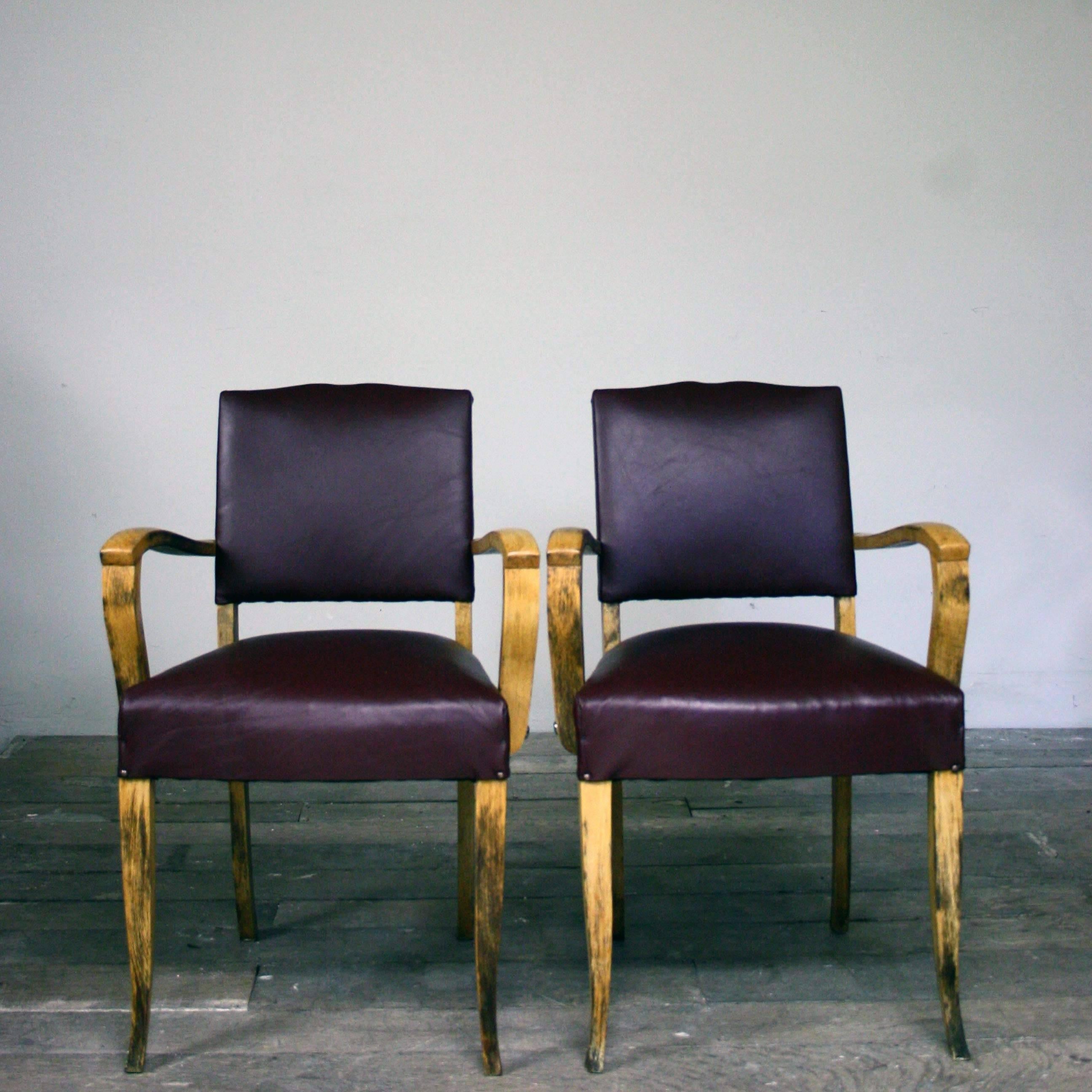 A pair of 1930s moustache back bridge chairs, that have been reupholstered in a Burgundy leather and black velvet back as the original material could not be saved. Very stylish, clean and tidy.

Additional dimensions: Armrest Height - 64.5cm
