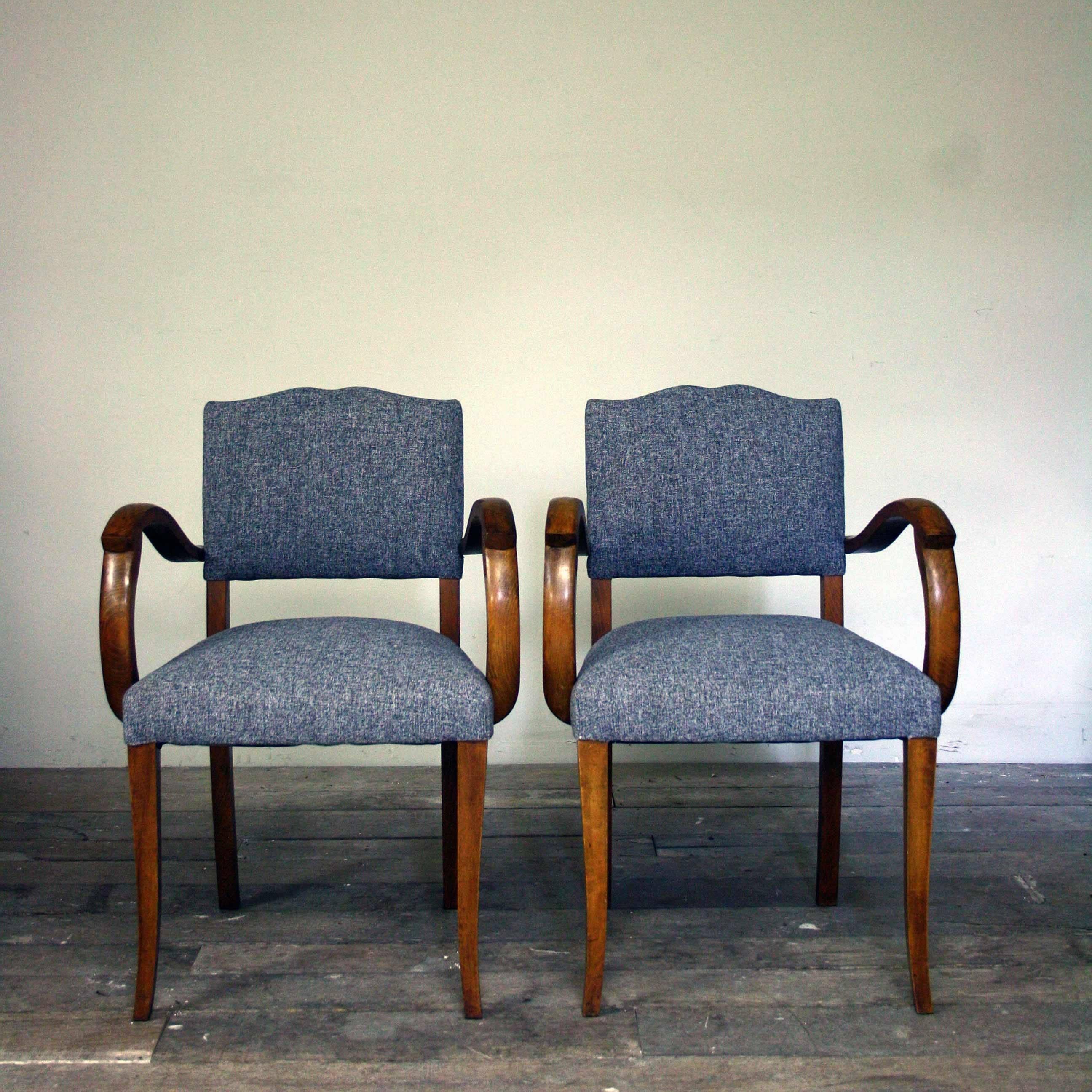 A stunning flecked grey linen reupholstered pair of 1950s moustache back bridge chairs with unusual 