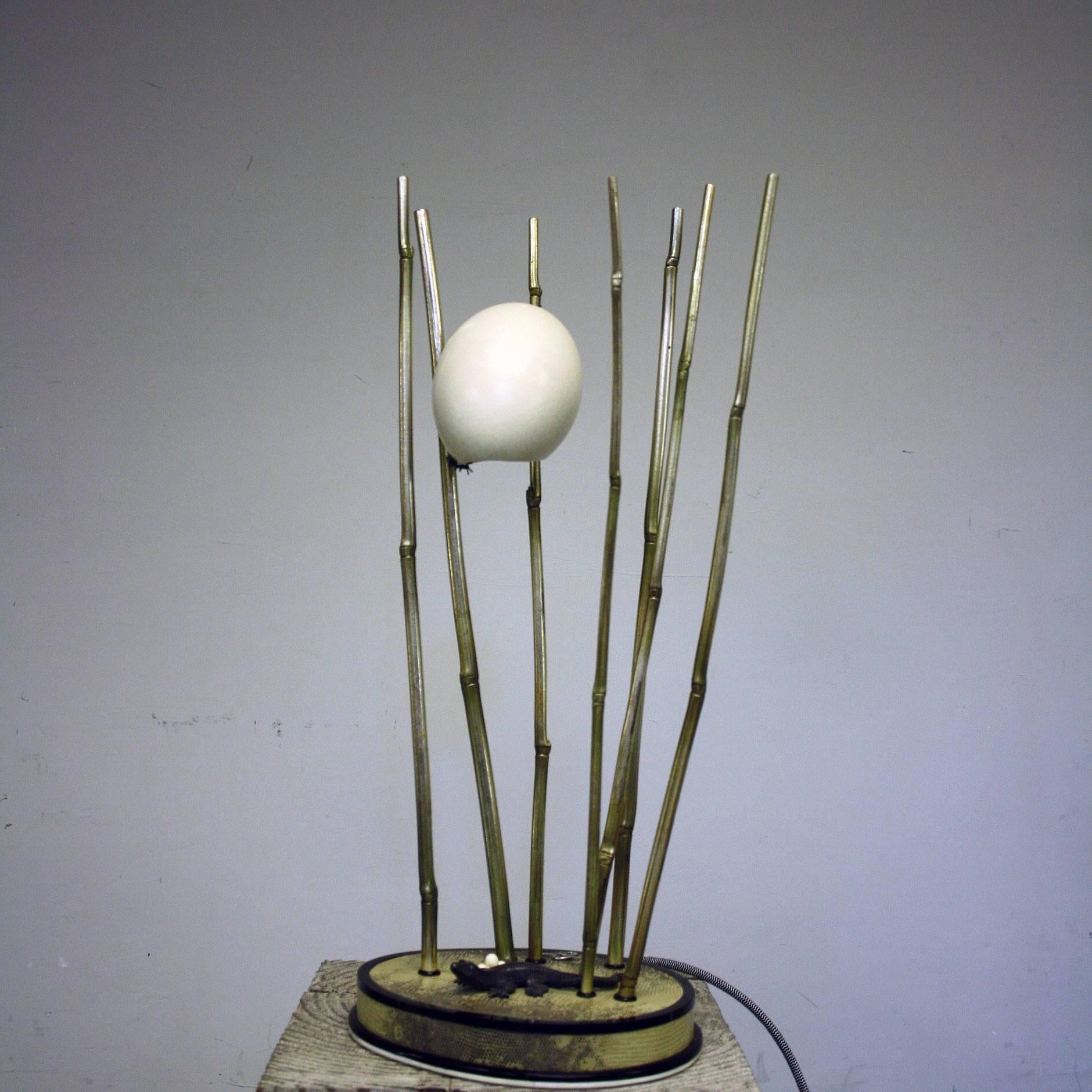A Rhea egg lamp by Glyn Lockett, with silvered brass bamboo, bronze lizard and bone eggs on buffalo horn and monitor lizard veneered base with makers silver monogram, the egg applied with silver ants.

This is a fantastic opportunity to start
