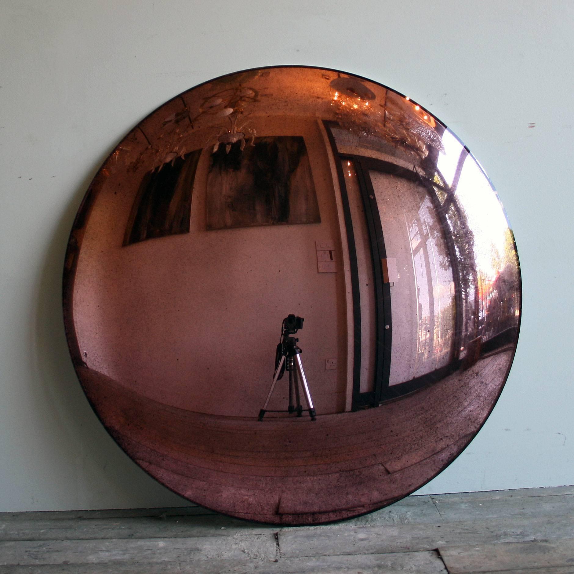 A large blue convex mirror 100cm in diameter with three bespoke clips for wall installation. A real statement piece!

All color mirrors have a two - three week lead time as all made to order.

As each mirror is bespoke made, will need a 50%