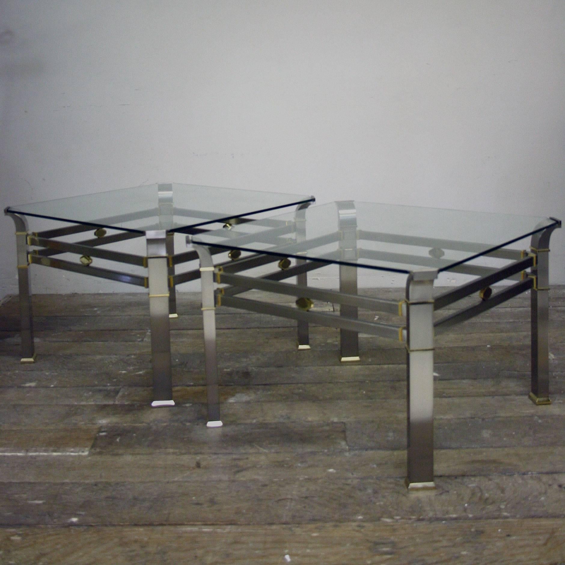 A pair of late 20th century very high quality and heavy duty side tables of brushed steel and brass with a glass top.